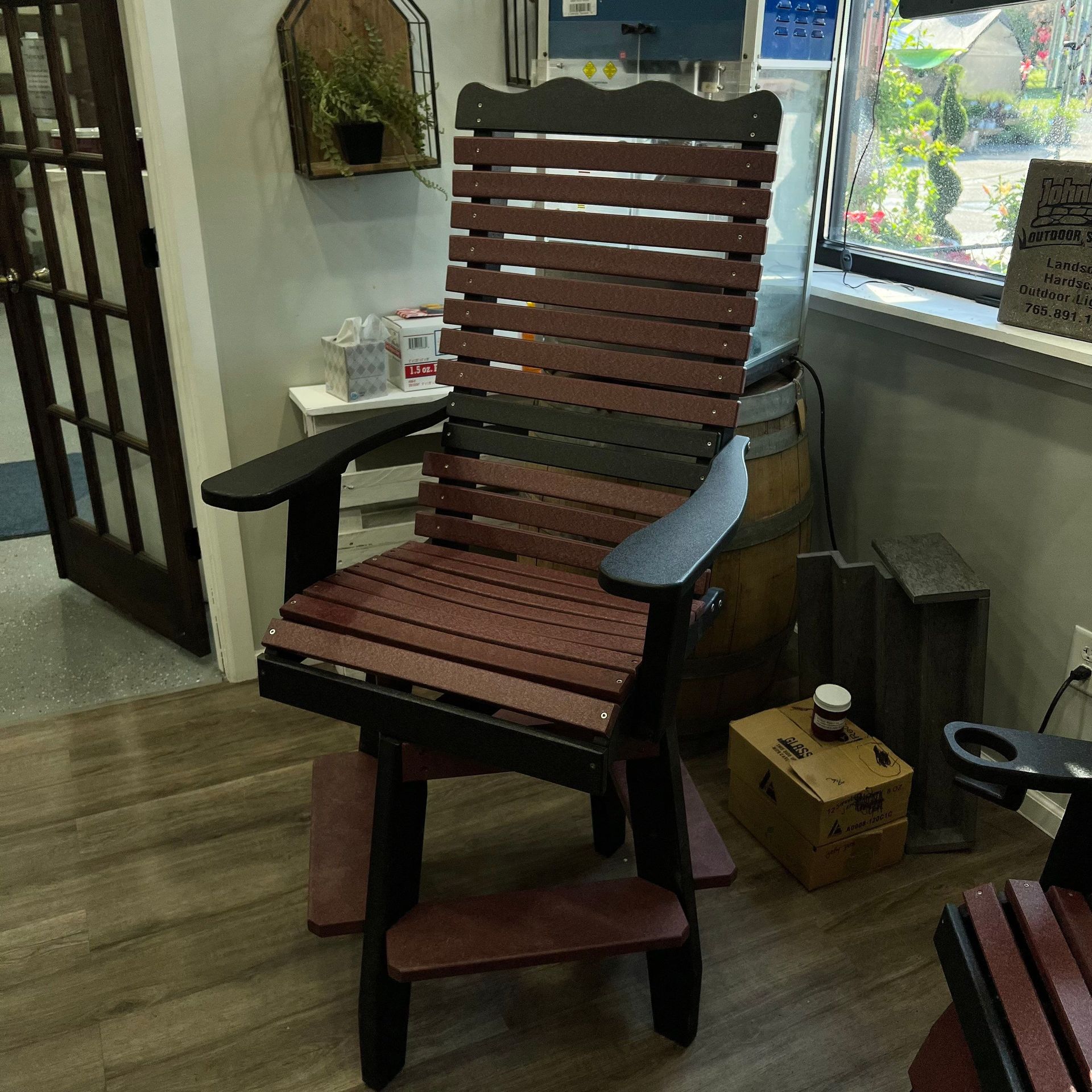 A wooden chair is sitting in a room next to a window