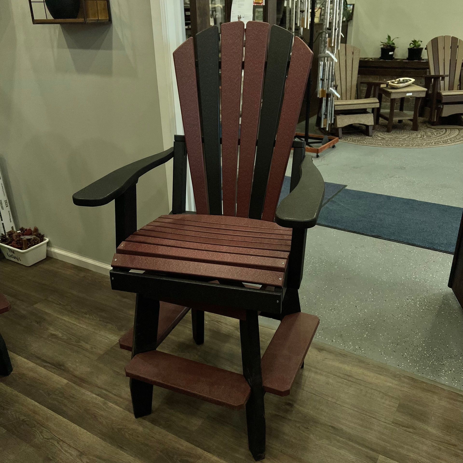 A red and black chair is sitting on a wooden floor