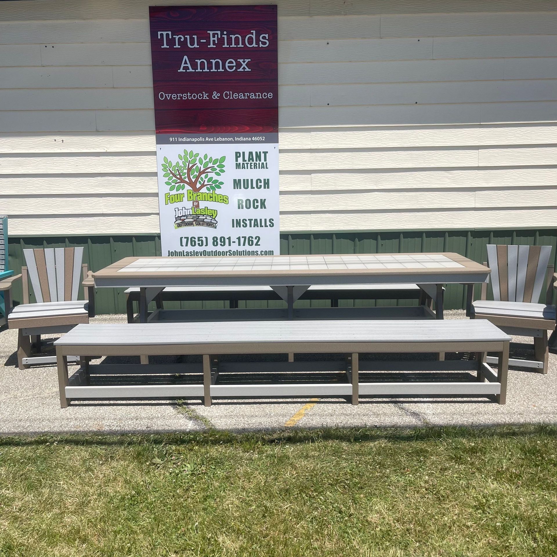 A tru-finds annex sign hangs above a picnic table and chairs