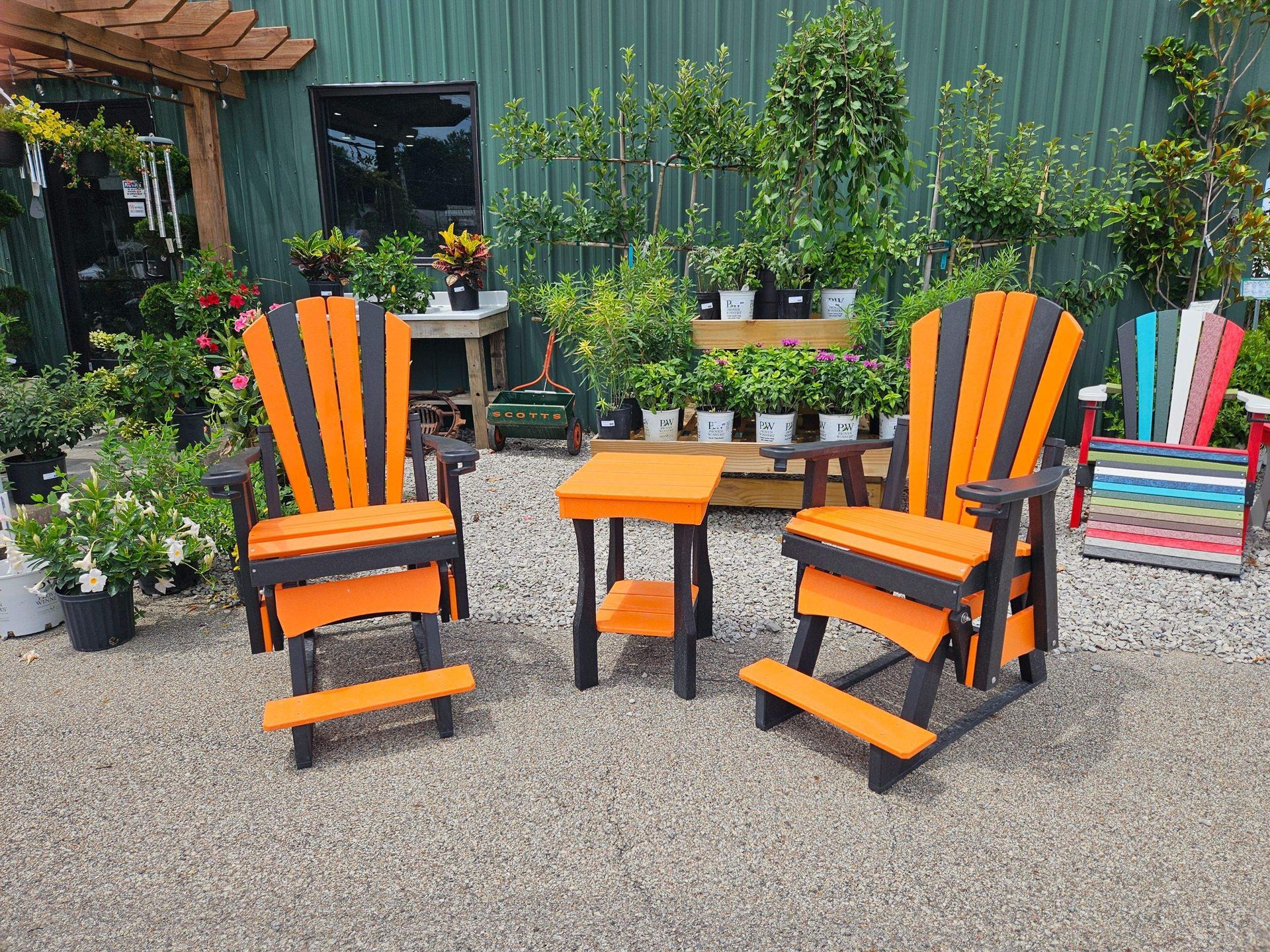 A patio set with two chairs and a table in front of a building.