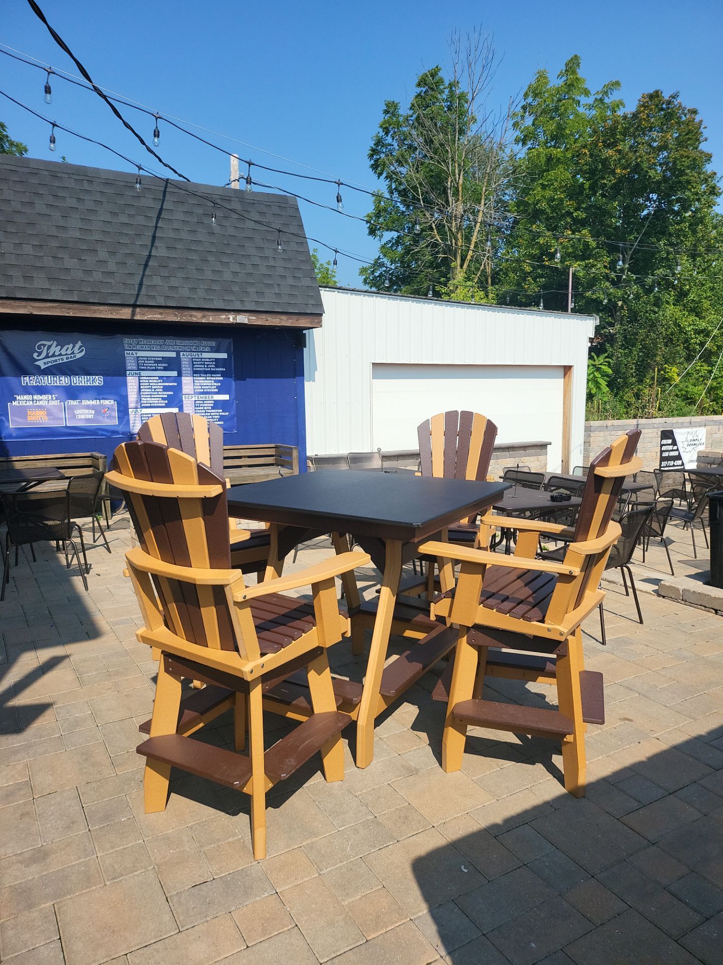 A table and chairs are sitting on a patio in front of a building.