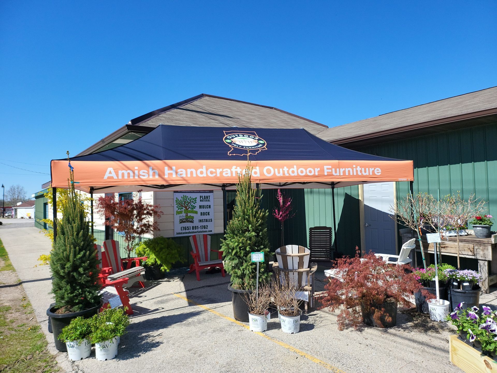 An amish handcraft and outdoor furniture store with lots of potted plants