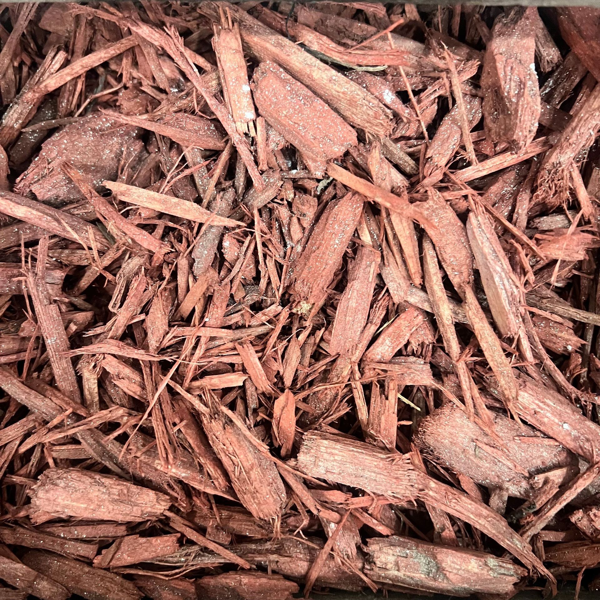 A pile of red mulch is sitting on a table.