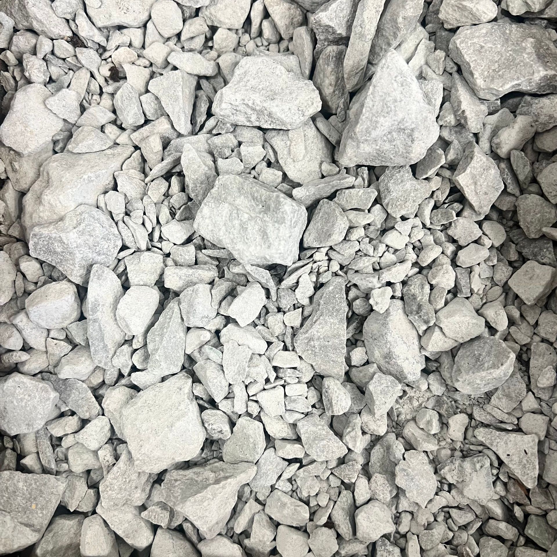 A pile of rocks sitting on top of each other on the ground.