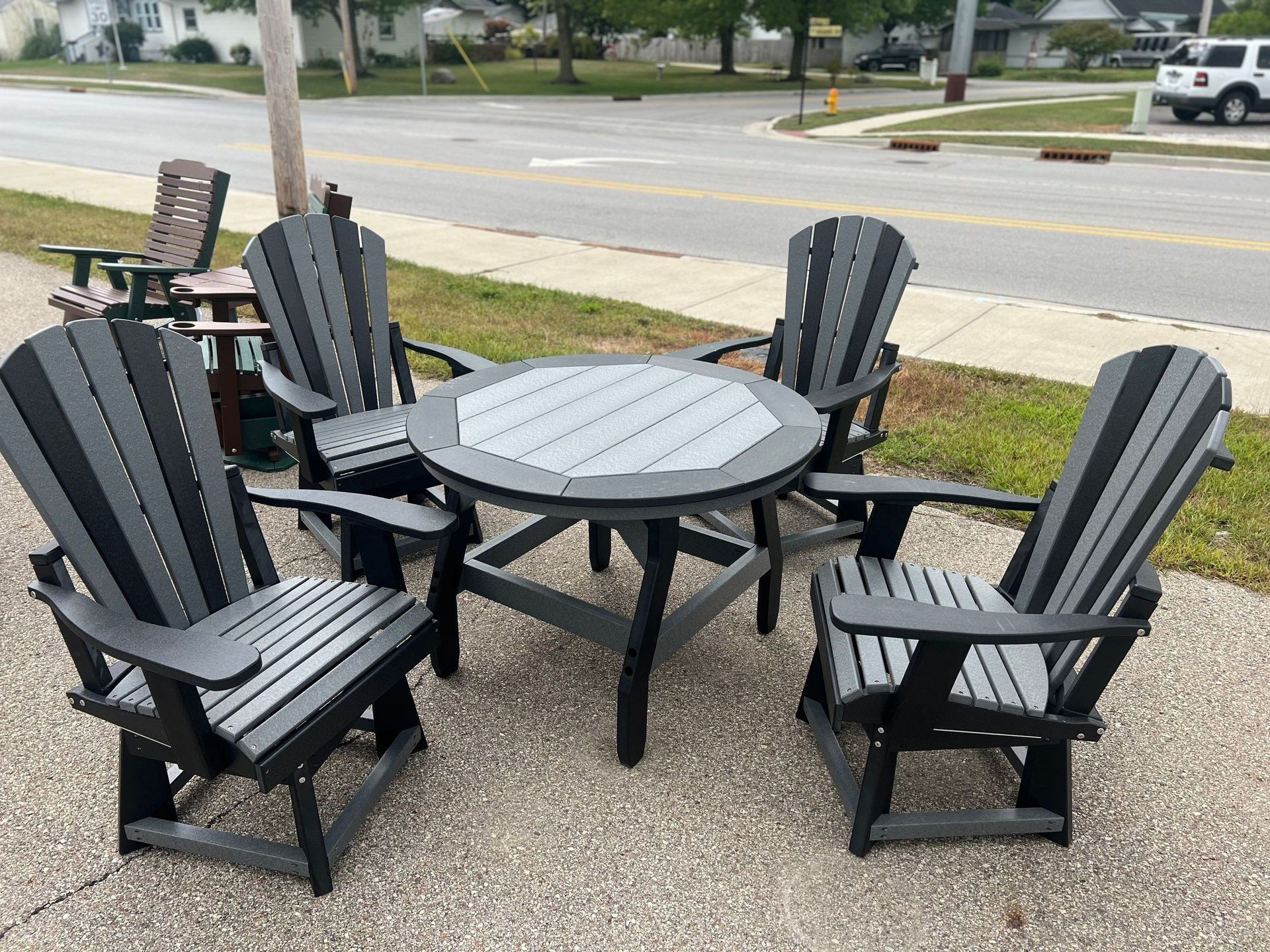 A table and chairs are sitting on the side of the road.