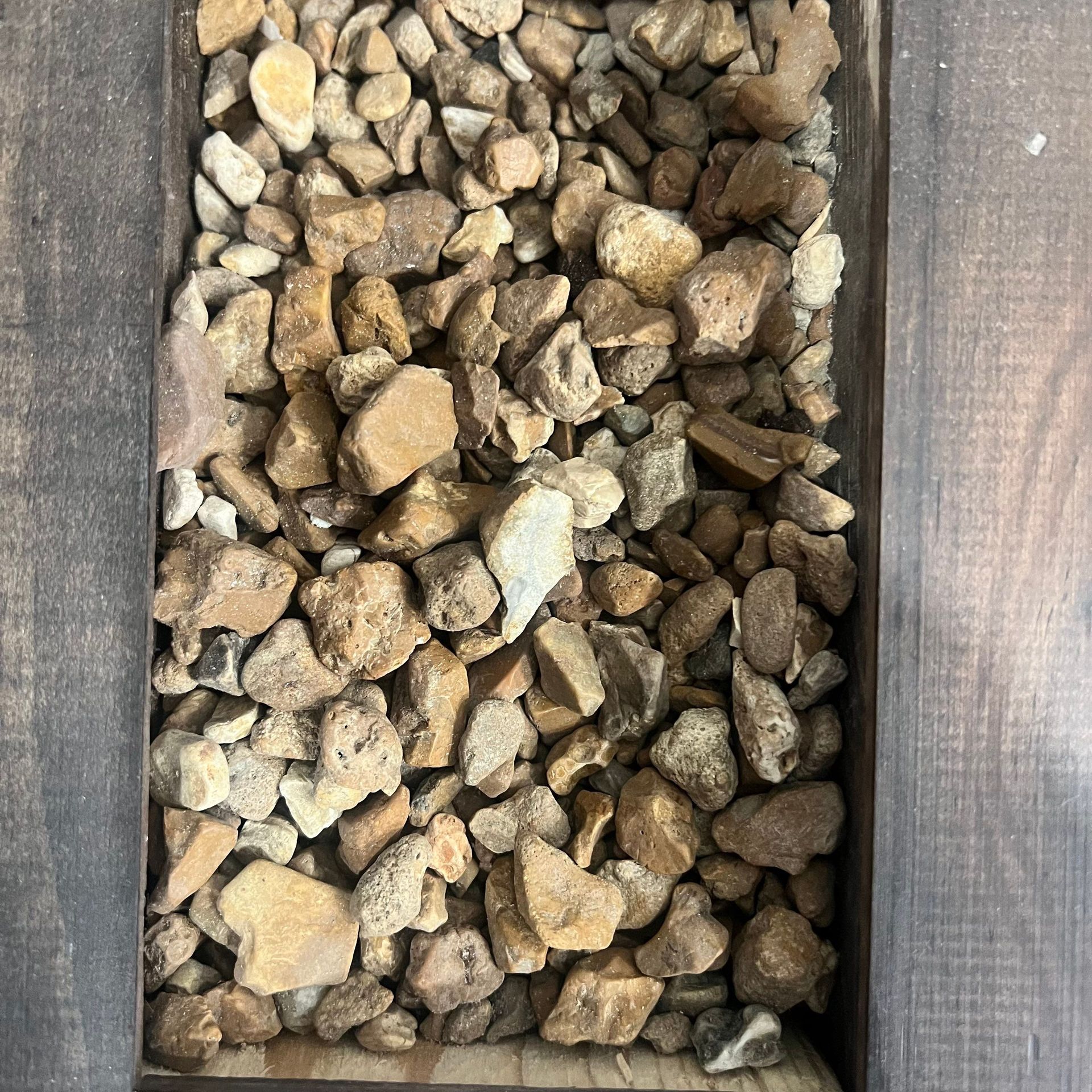 A pile of rocks in a wooden box