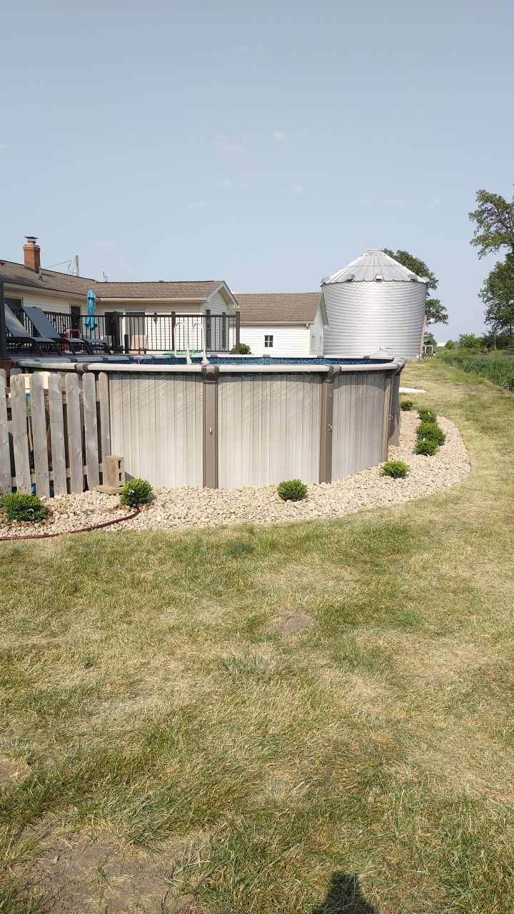 There is a swimming pool in the backyard of a house.