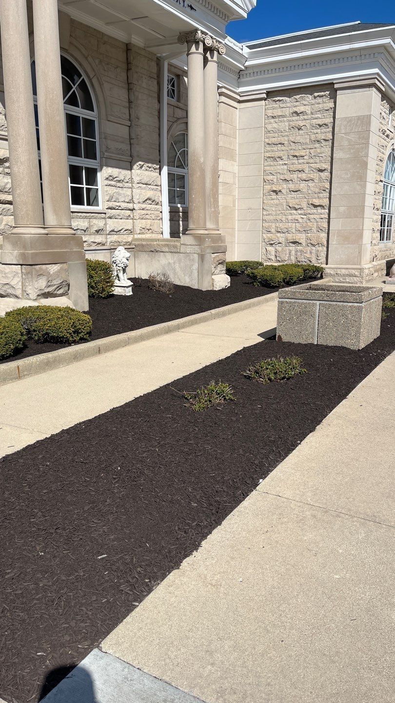 A sidewalk leading to a building with a statue in front of it.