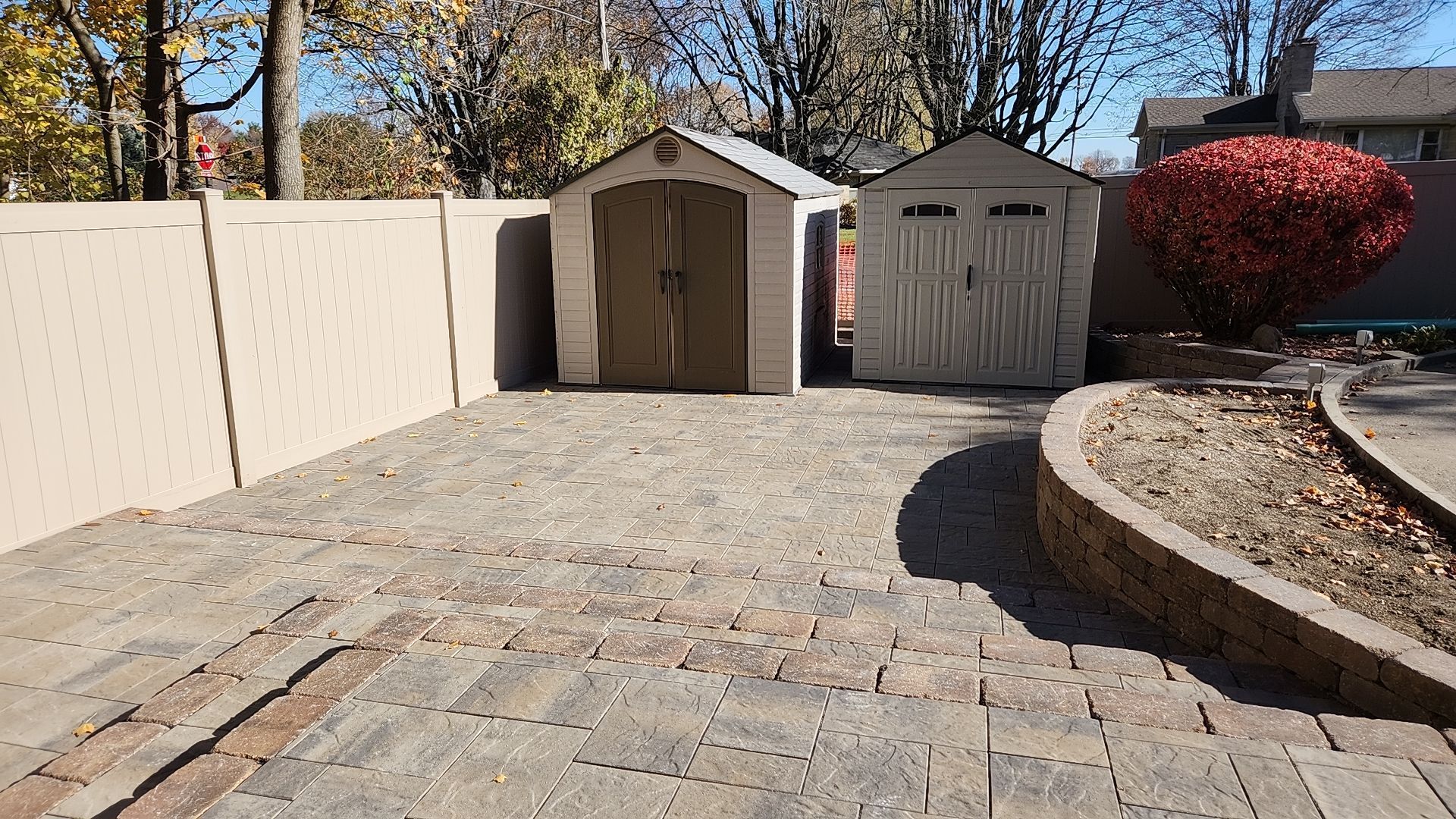 There is a shed and a garage in the backyard.