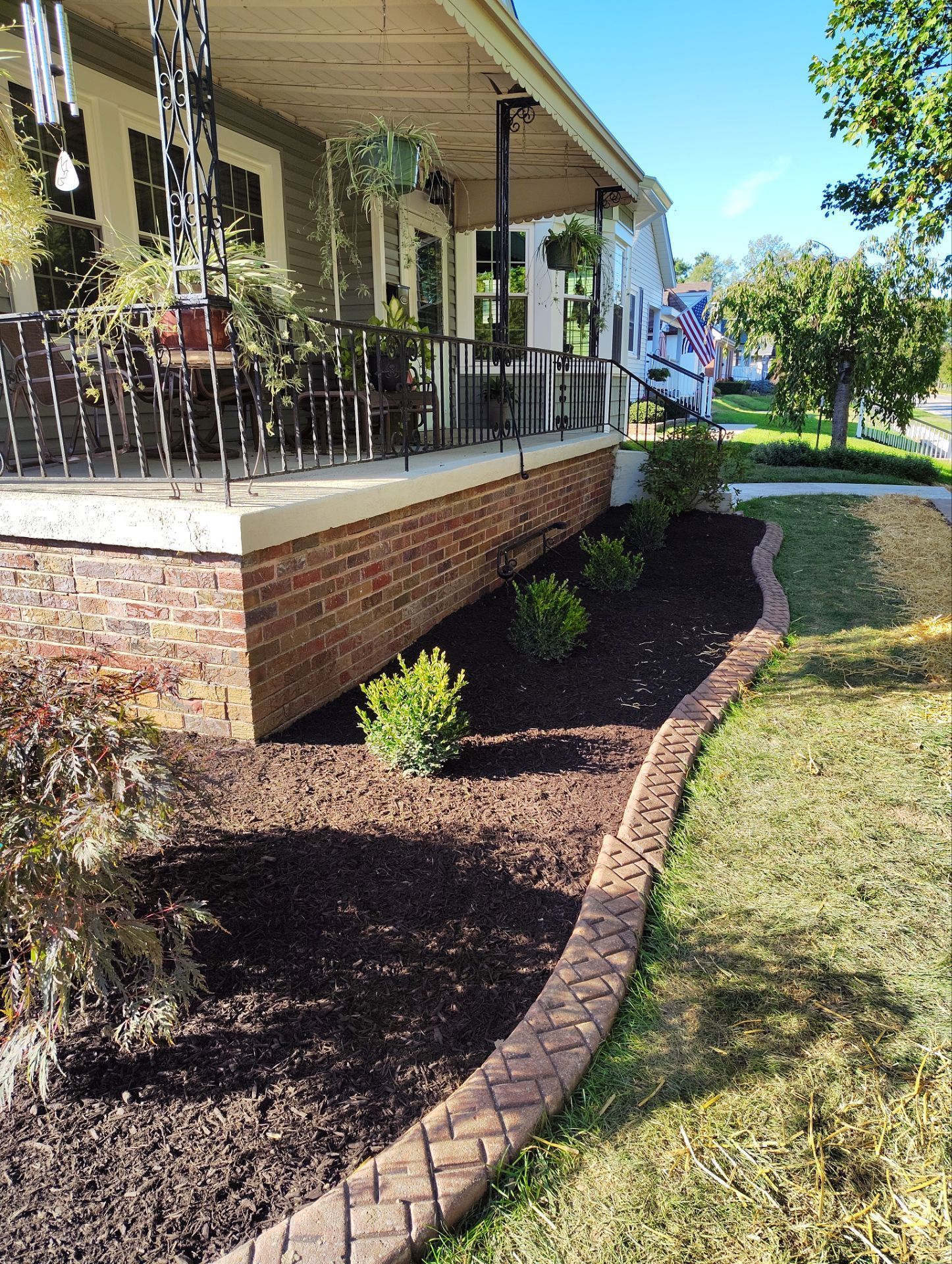 A house with a porch and a brick walkway
