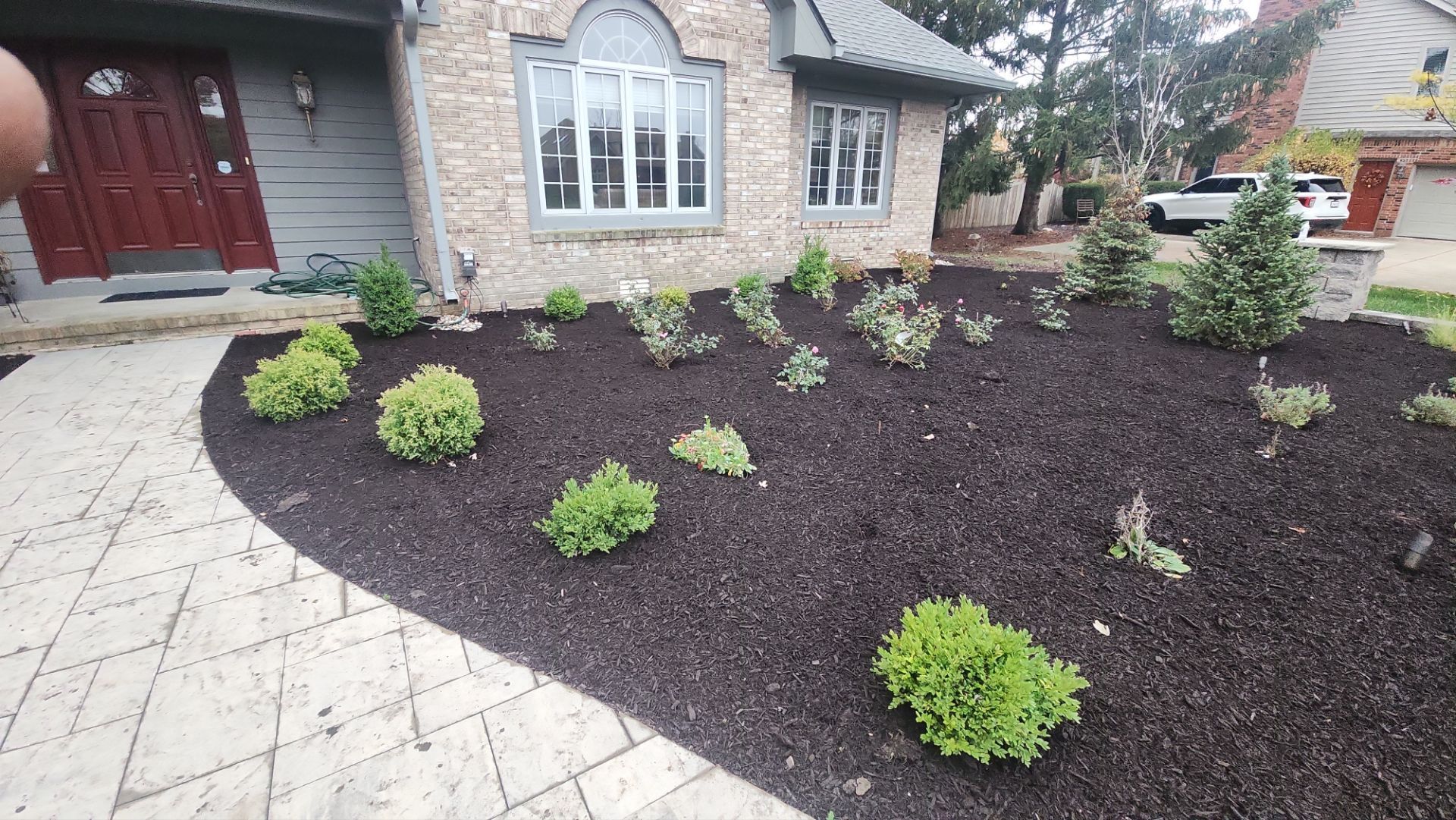 A house with a lot of plants in front of it