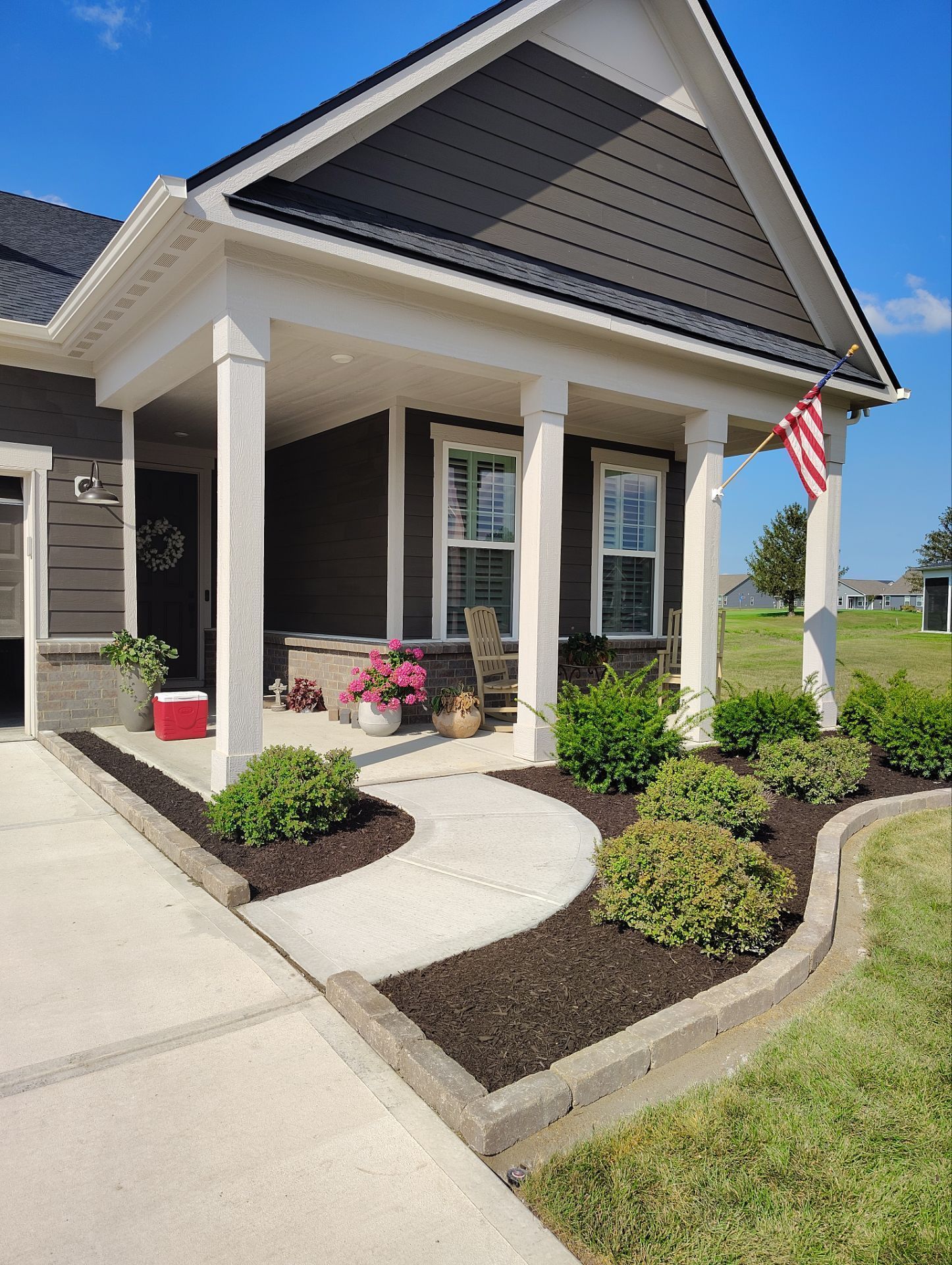 A house with a porch and a flag on it