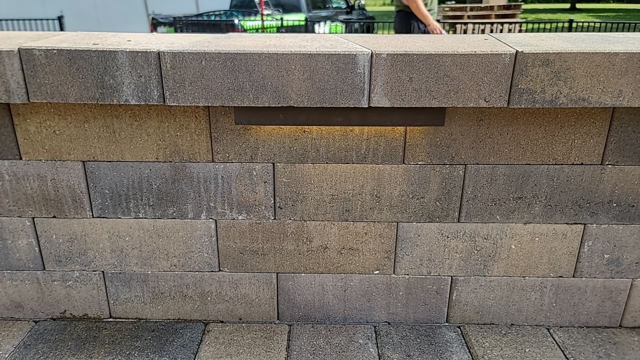 A brick wall with a light built into it.