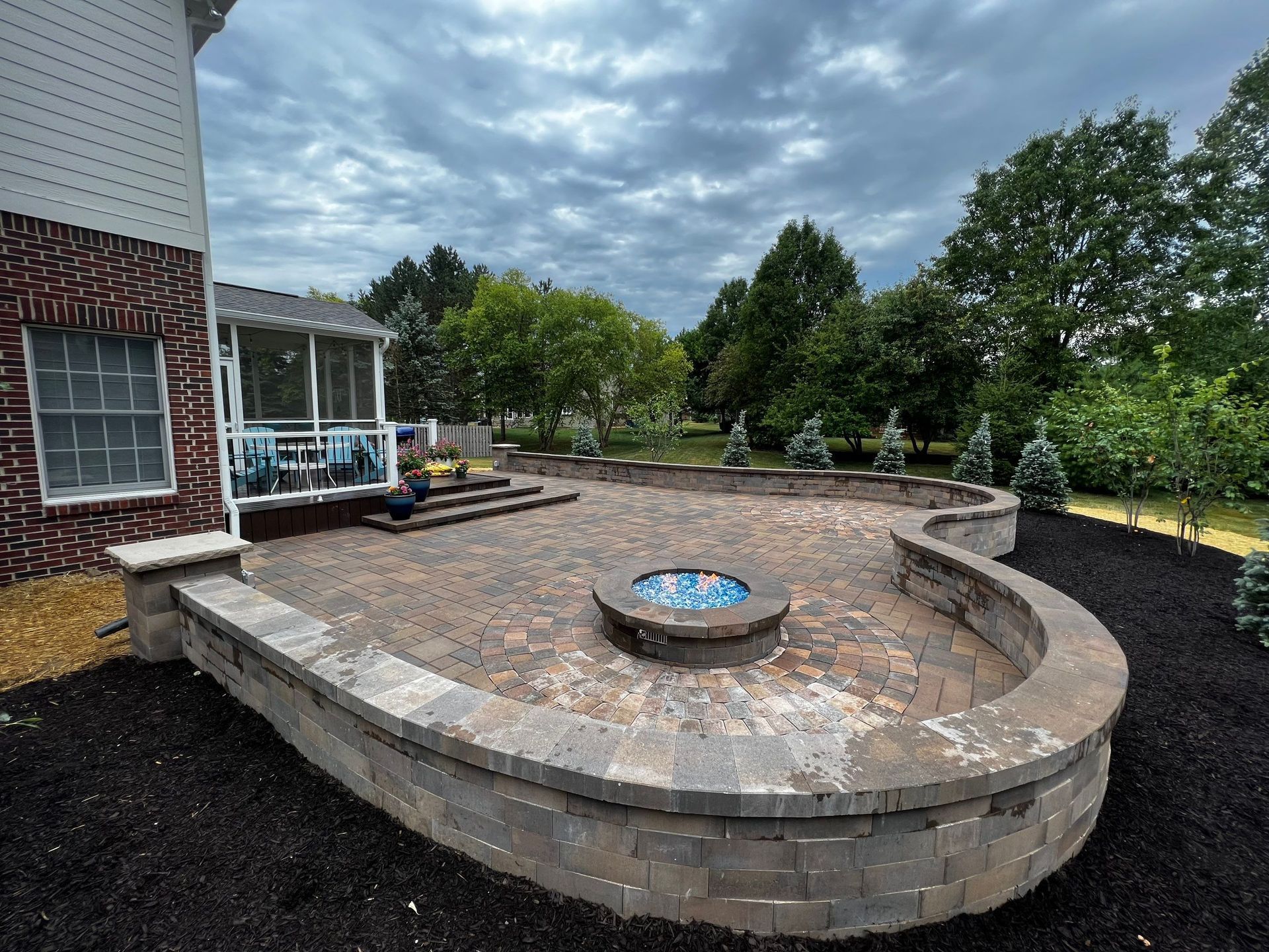There is a fire pit in the middle of the patio.