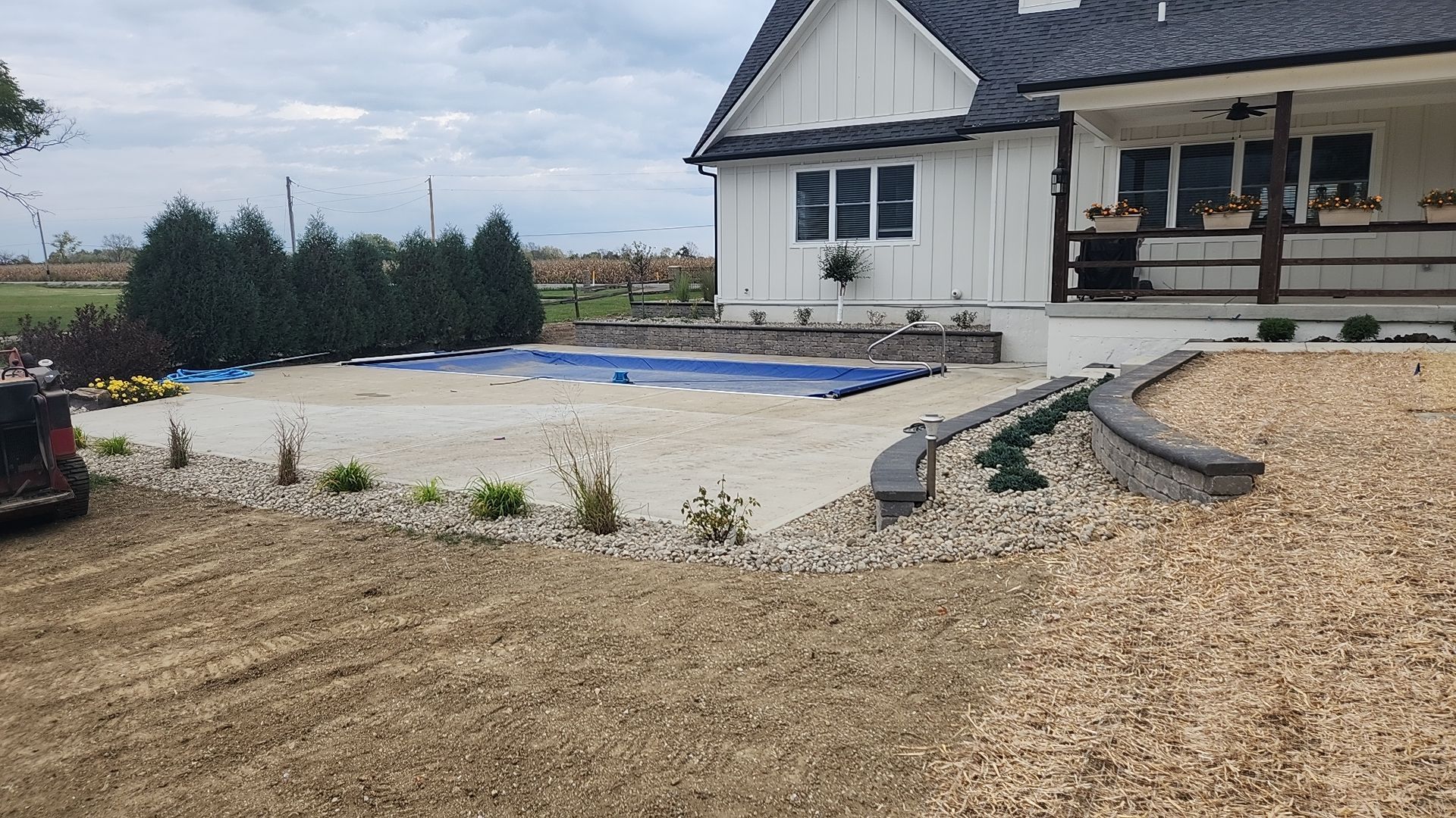 A large white house with a swimming pool in the backyard.