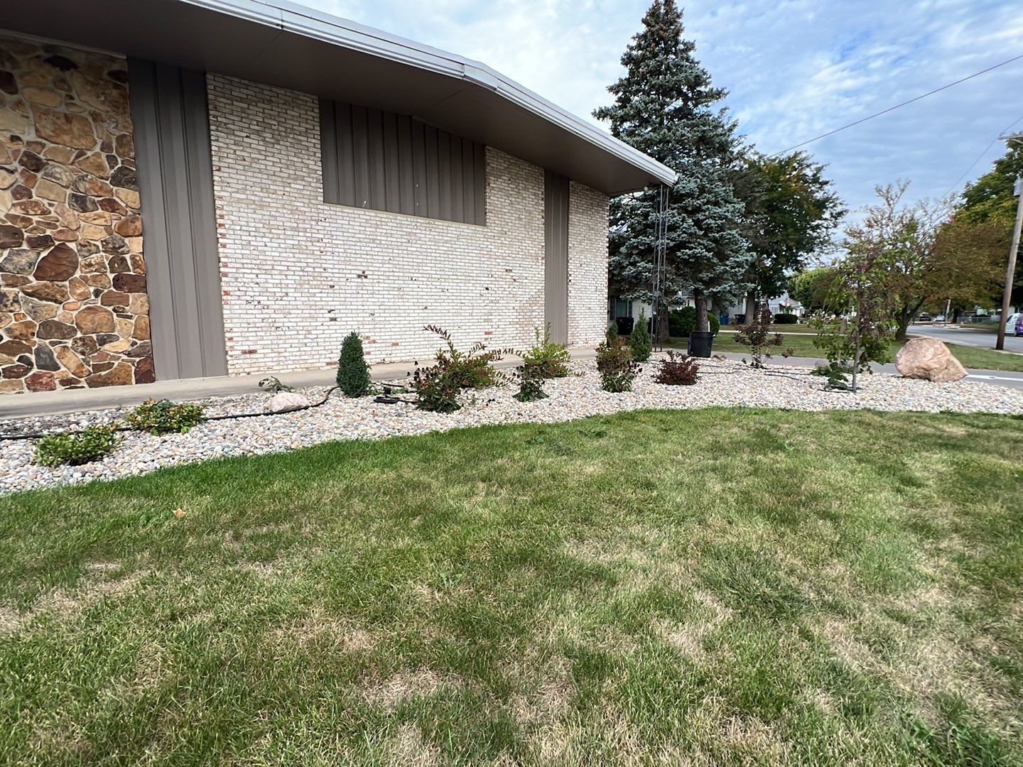 A house with a lush green lawn in front of it
