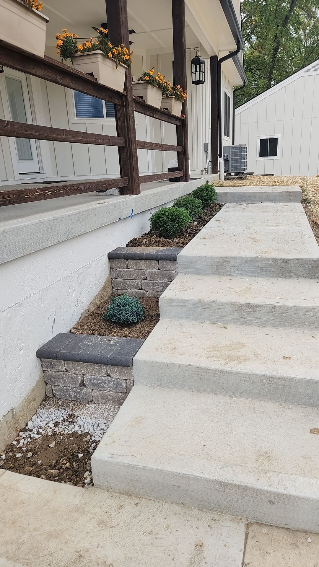 A set of stairs leading up to a porch of a house.