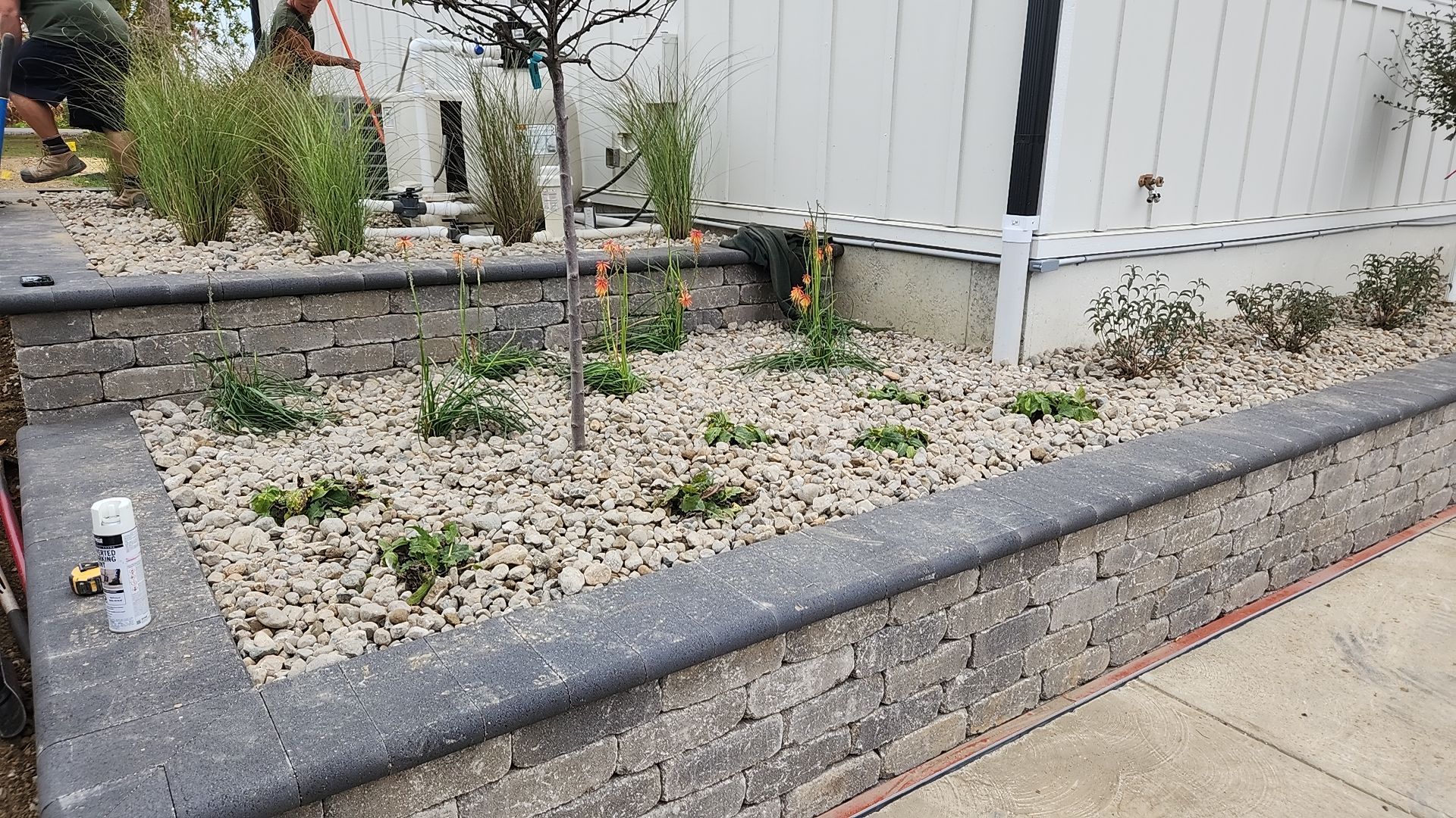 A garden is being built in front of a mobile home.