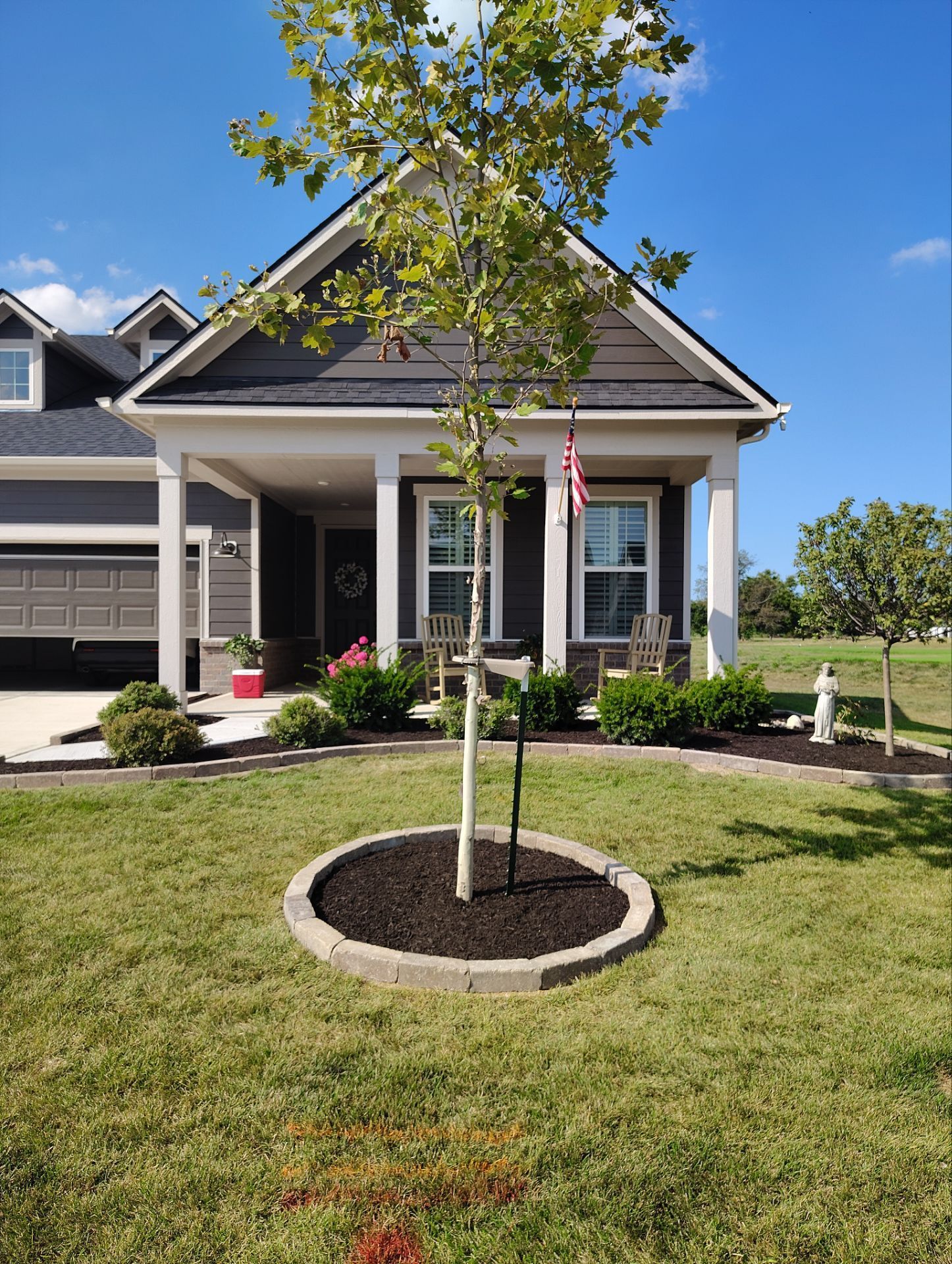 A house with a tree in front of it.