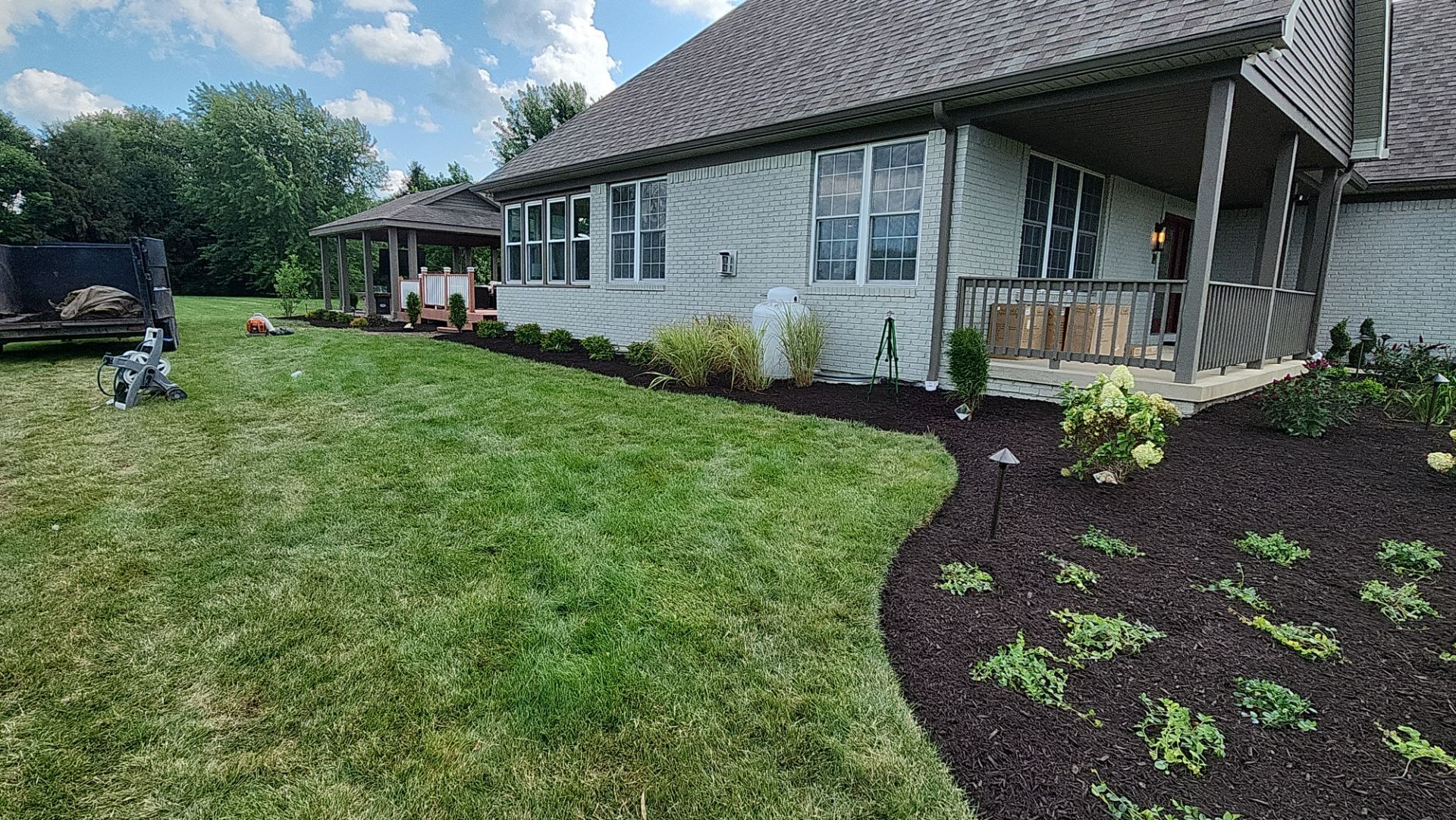 A large white house with a large lawn in front of it.