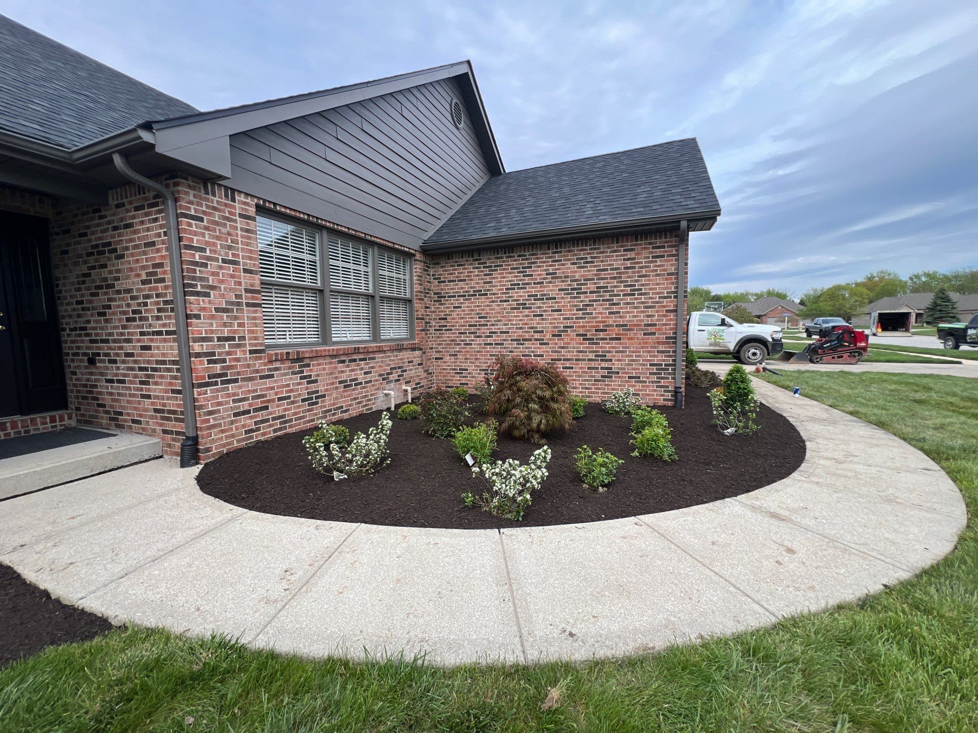 A brick house with a circular walkway in front of it.