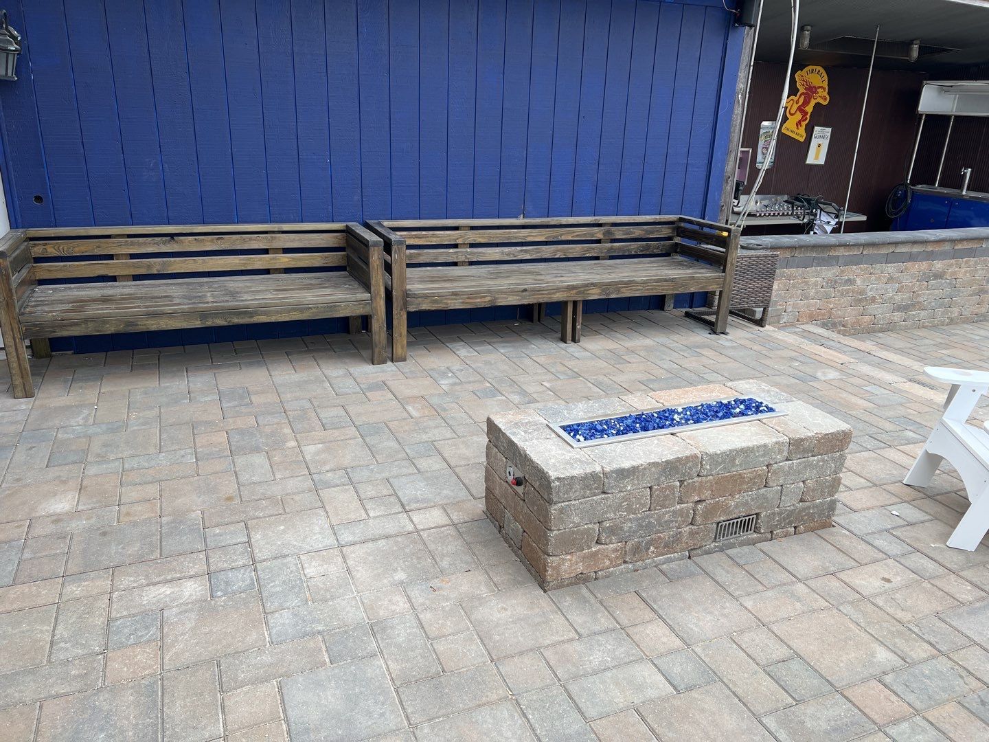 There is a fire pit in the middle of the patio.