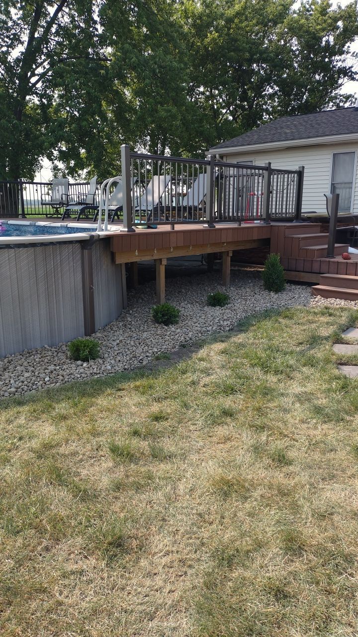 A house with a swimming pool and a deck in the backyard.
