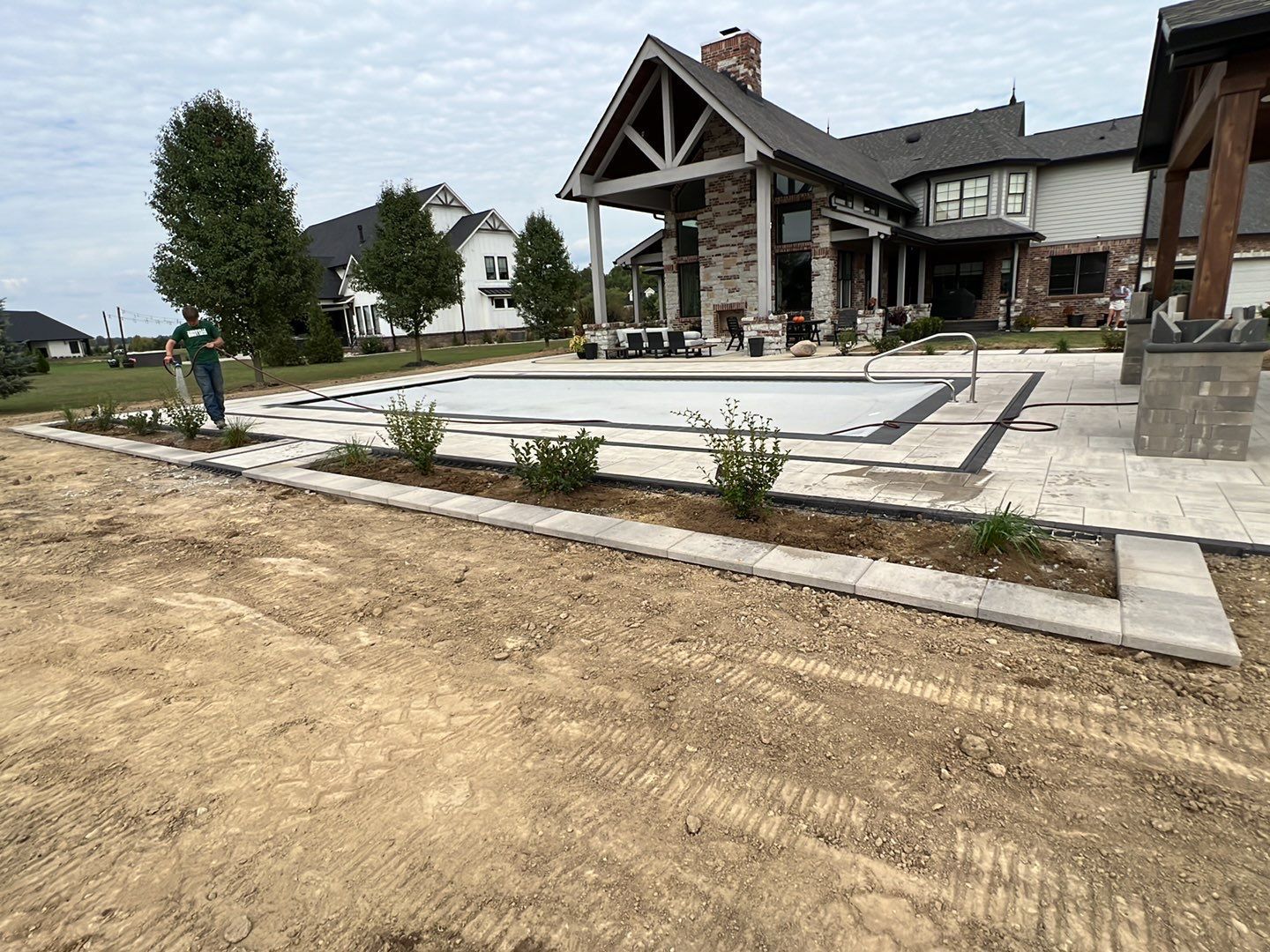 A large house with a large swimming pool in front of it.