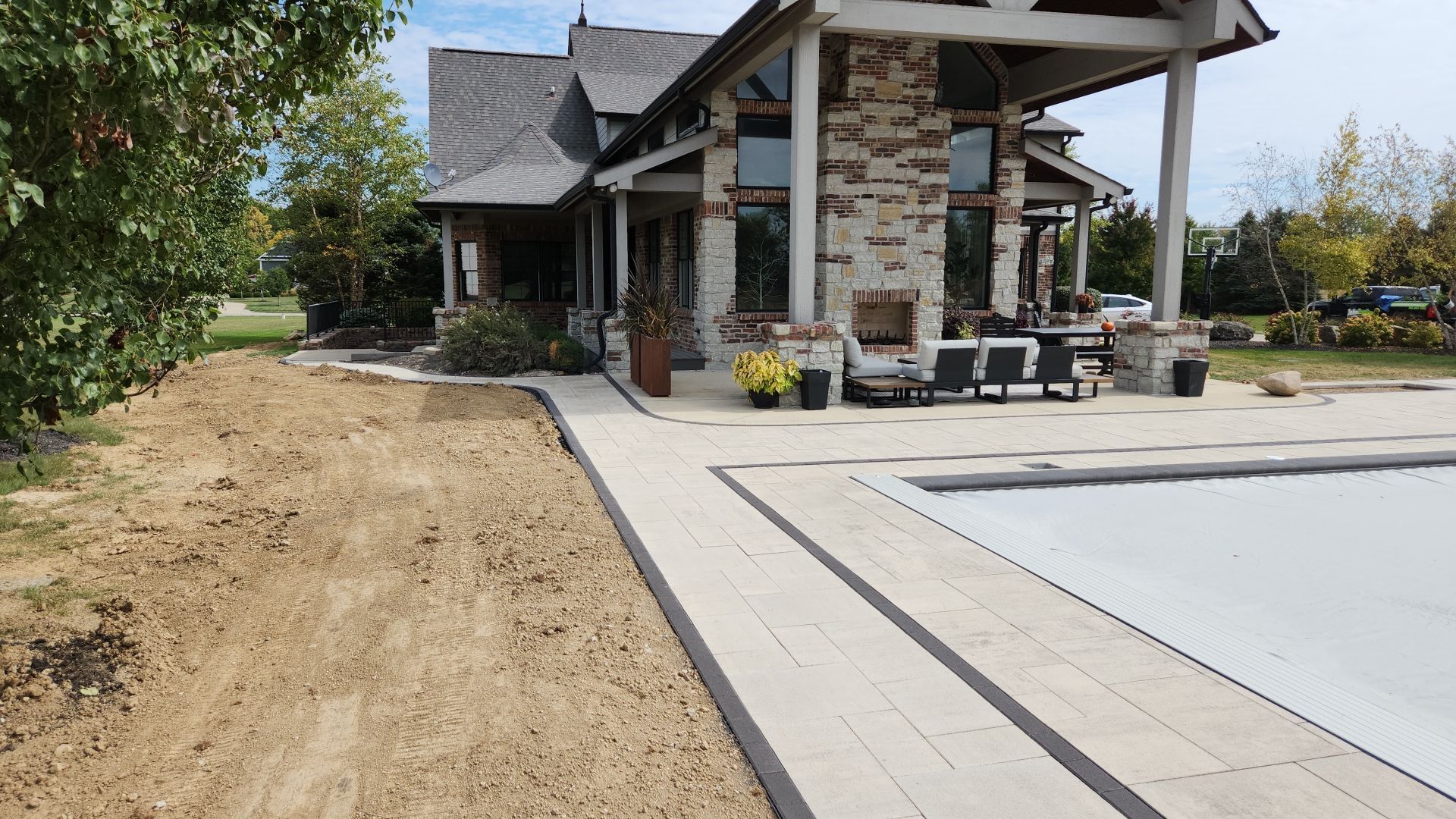 A large house with a swimming pool in front of it.
