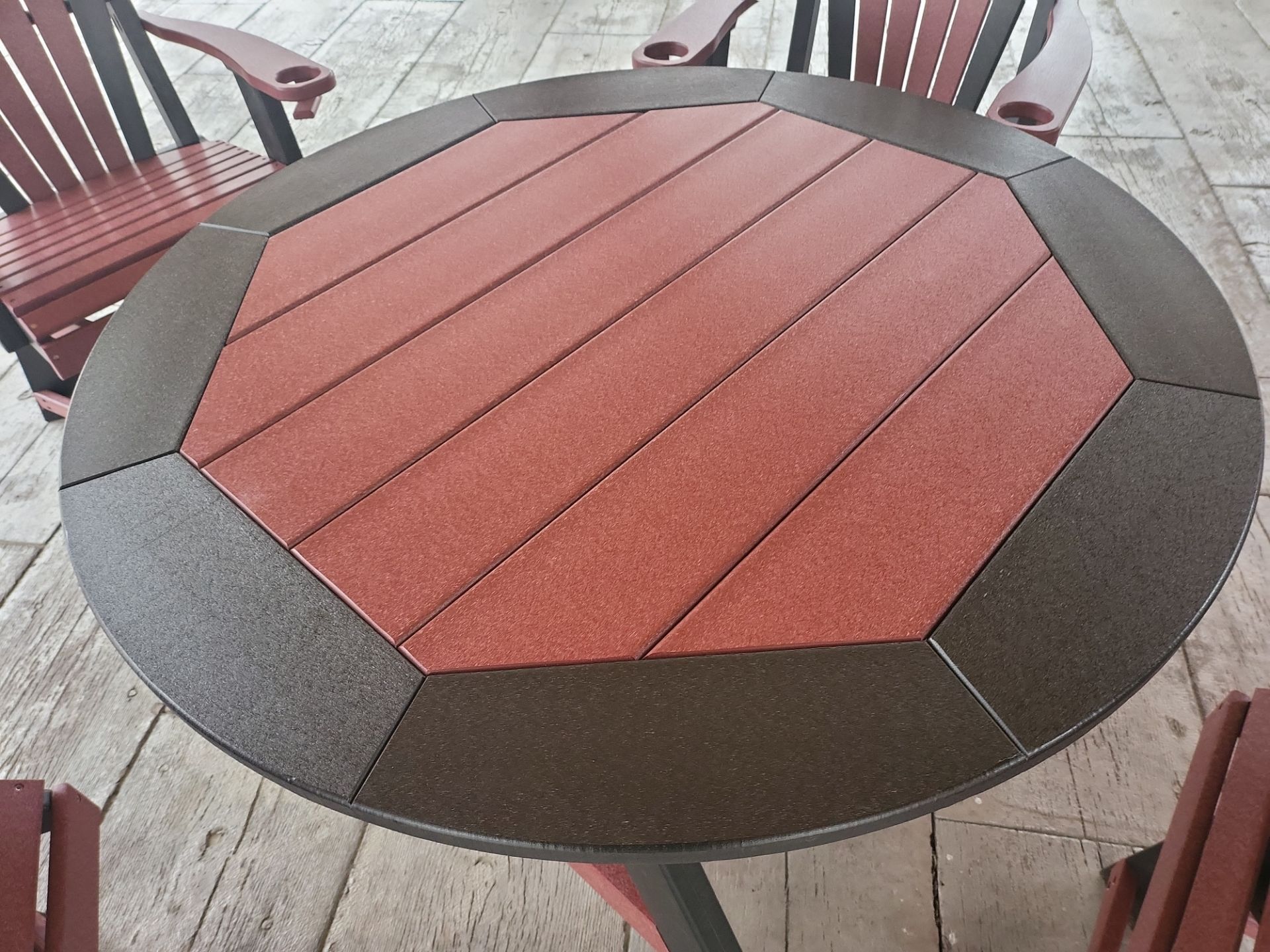A round table with a red top and a brown border