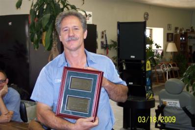 Professional Wrecker Service — Man Holding Certificate in Lake City, FL