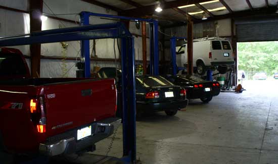Auto Repair Experts — Parked Vehicles in Shop in Lake City, FL