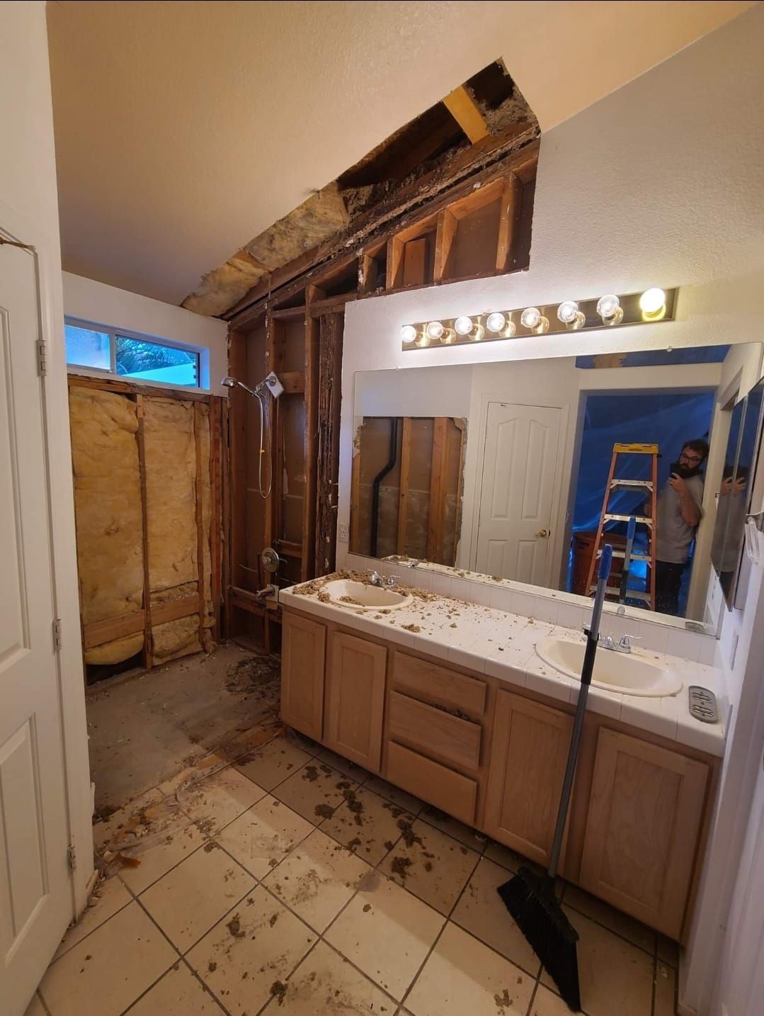 A bathroom with two sinks and a large mirror.