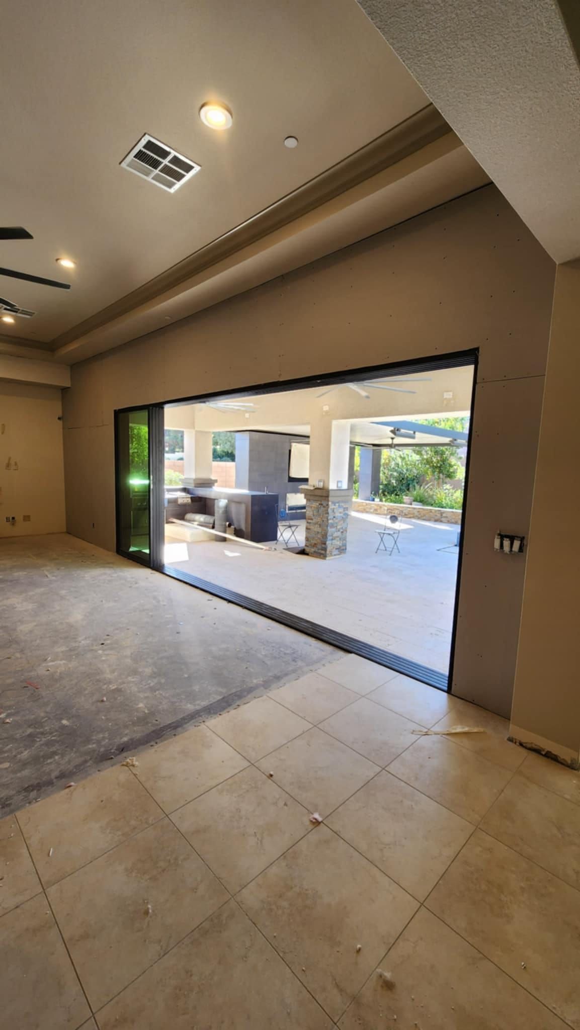 A large room with a sliding glass door leading to a patio.