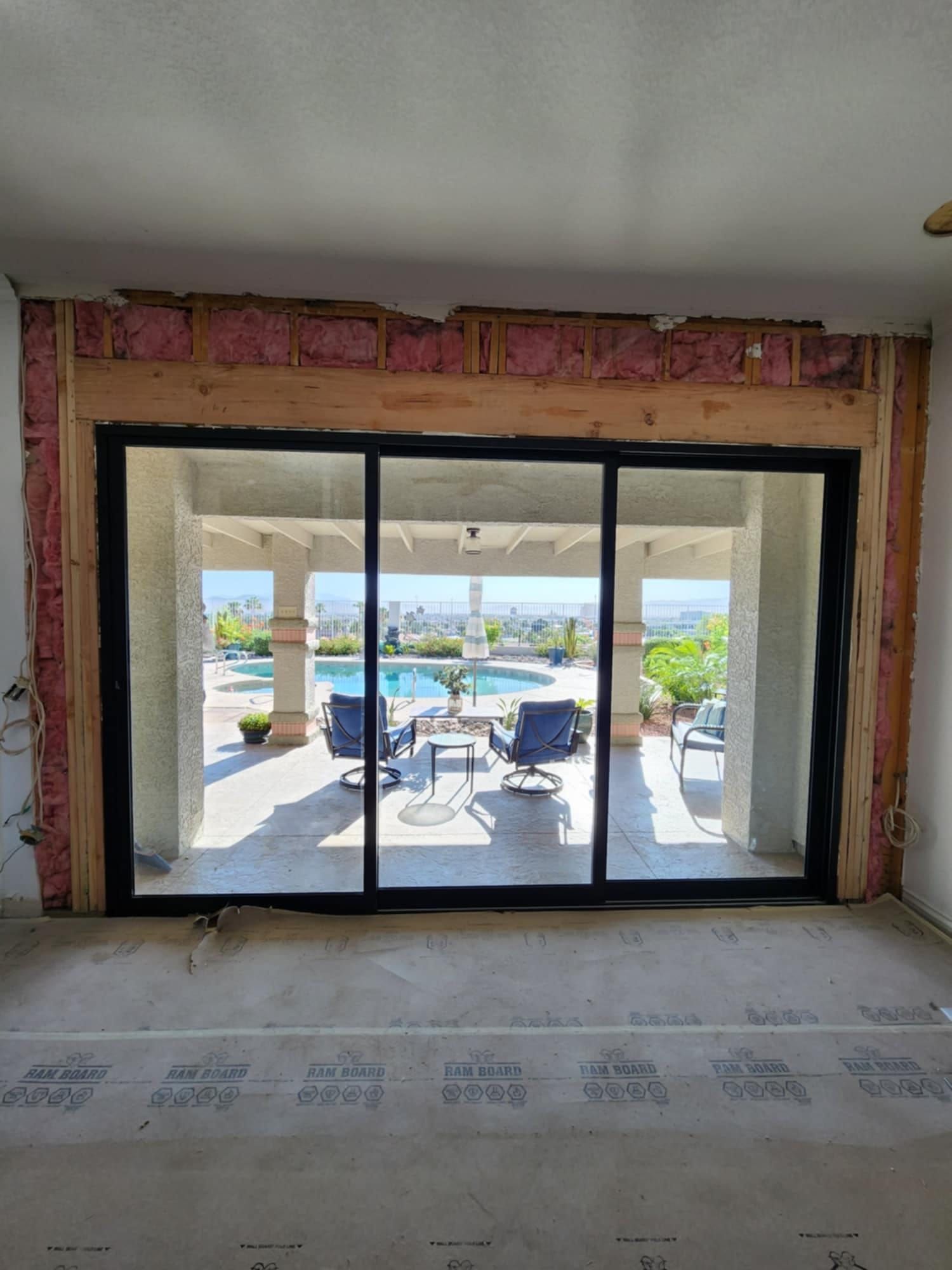 A room with a sliding glass door leading to a patio.