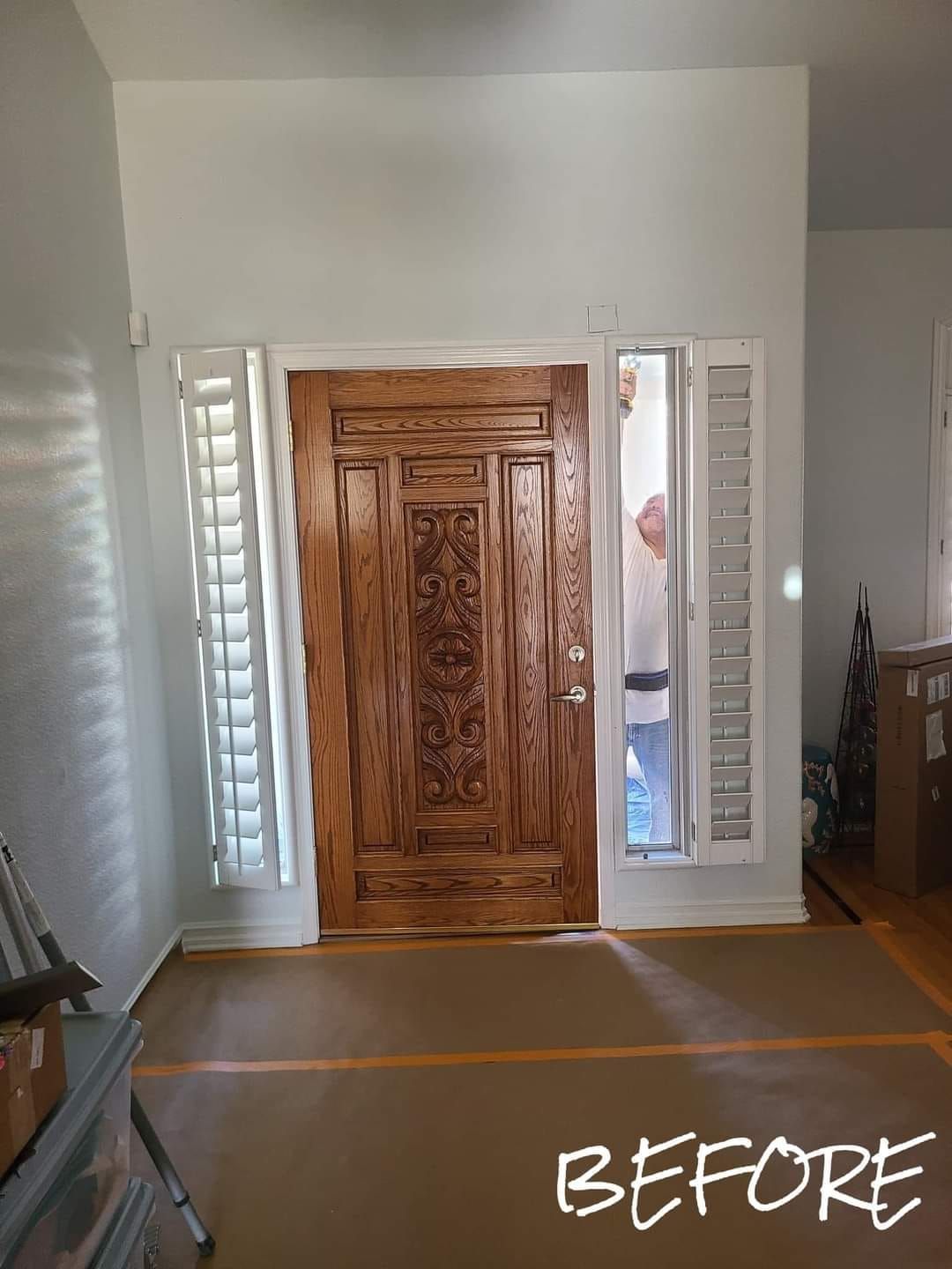 A before picture of a wooden door in a living room.