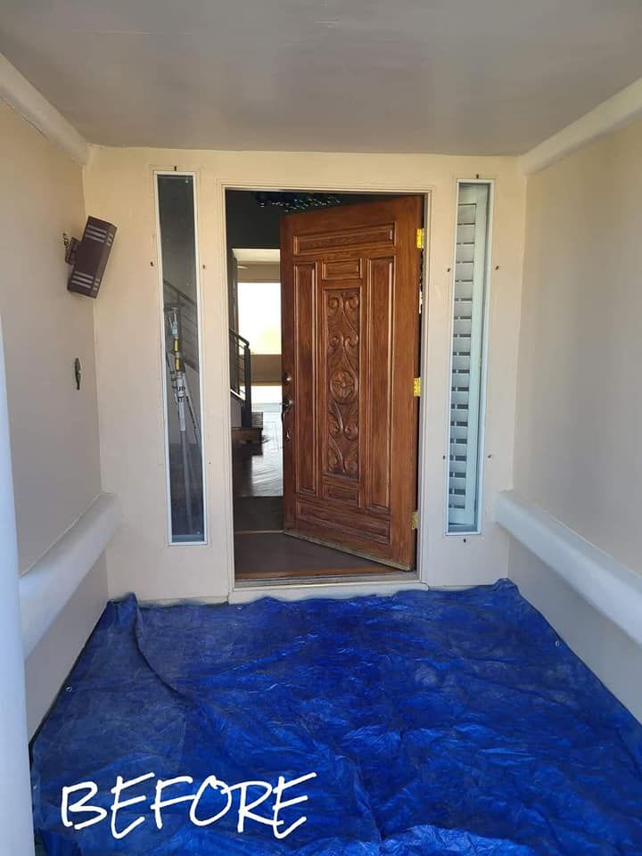 A before picture of a door with a blue tarp on the floor
