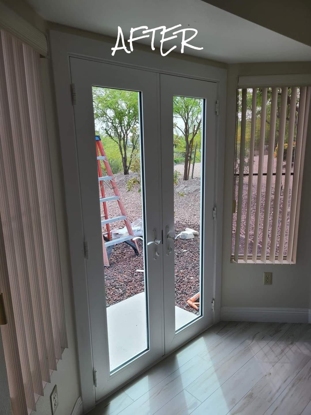 A room with sliding glass doors and a ladder in the background.