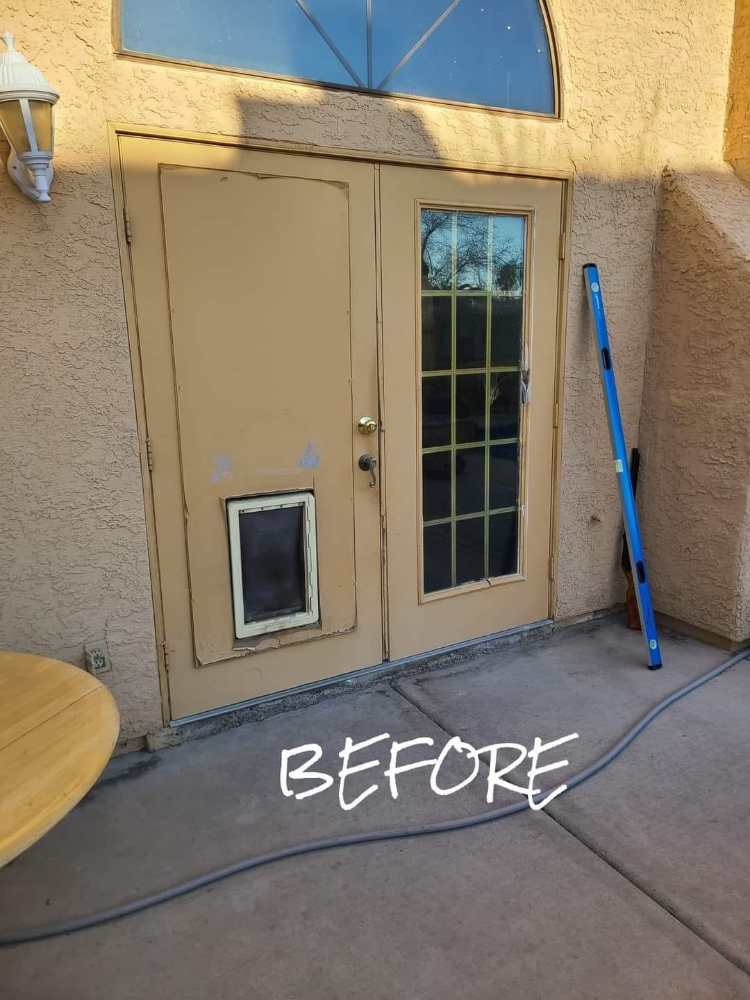 A before picture of a door with a cat door