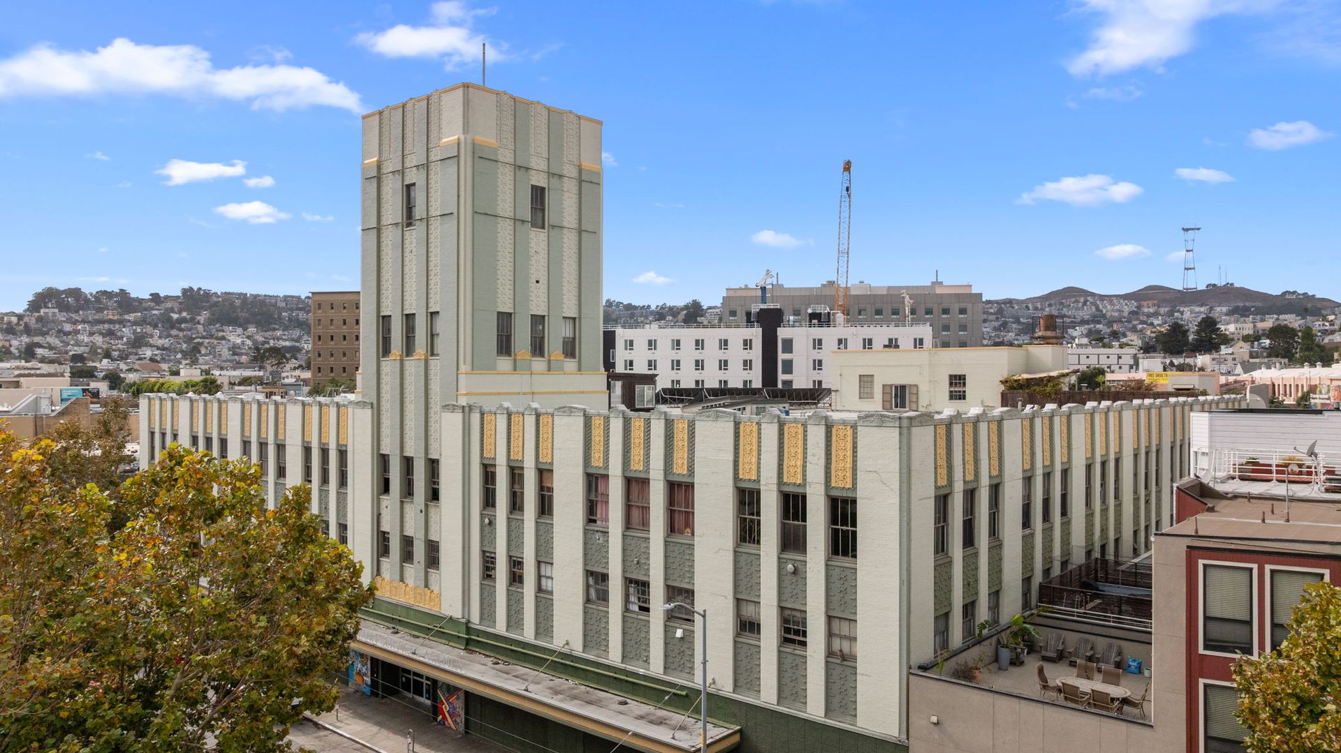 Art Deco building, exterior view, multi-story, light green with white trim, San Francisco, California.