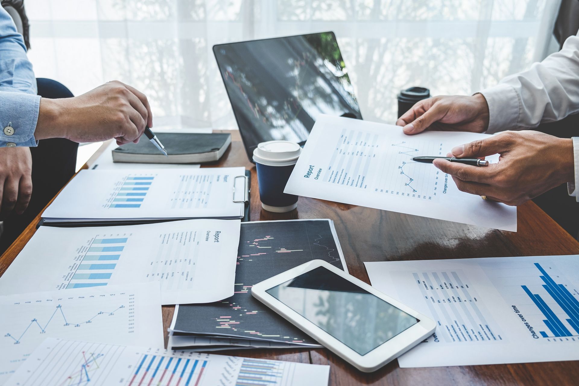 Woman sitting at a table looking at her laptop