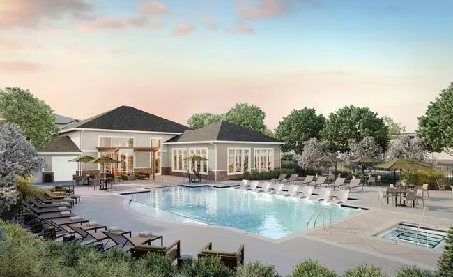 Multi-story brick building with green trim, arched doorway, and balcony.