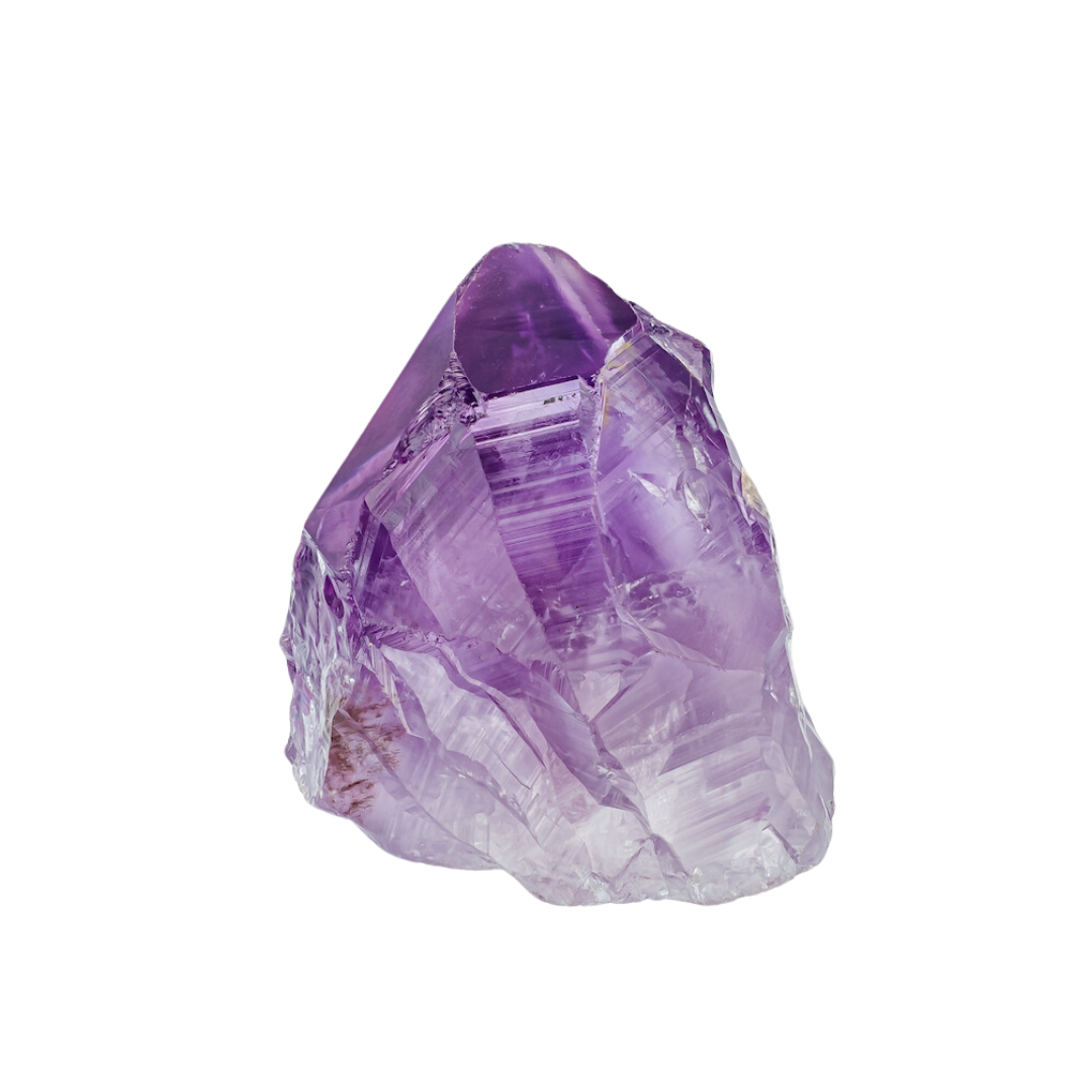 A close up of a purple amethyst crystal on a white background.