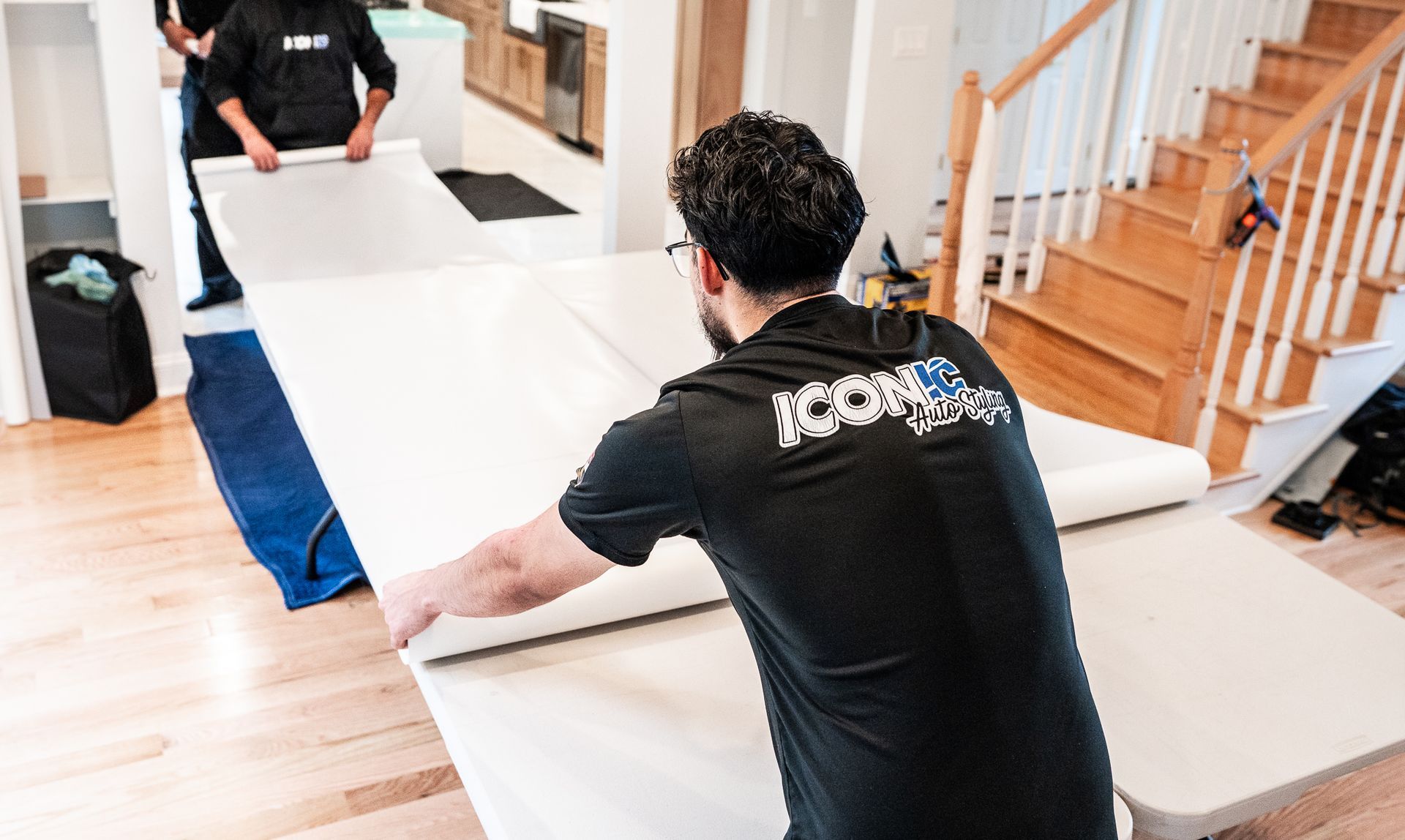 Kitchen with stainless steel appliances, white cabinets, and a mosaic backsplash.
