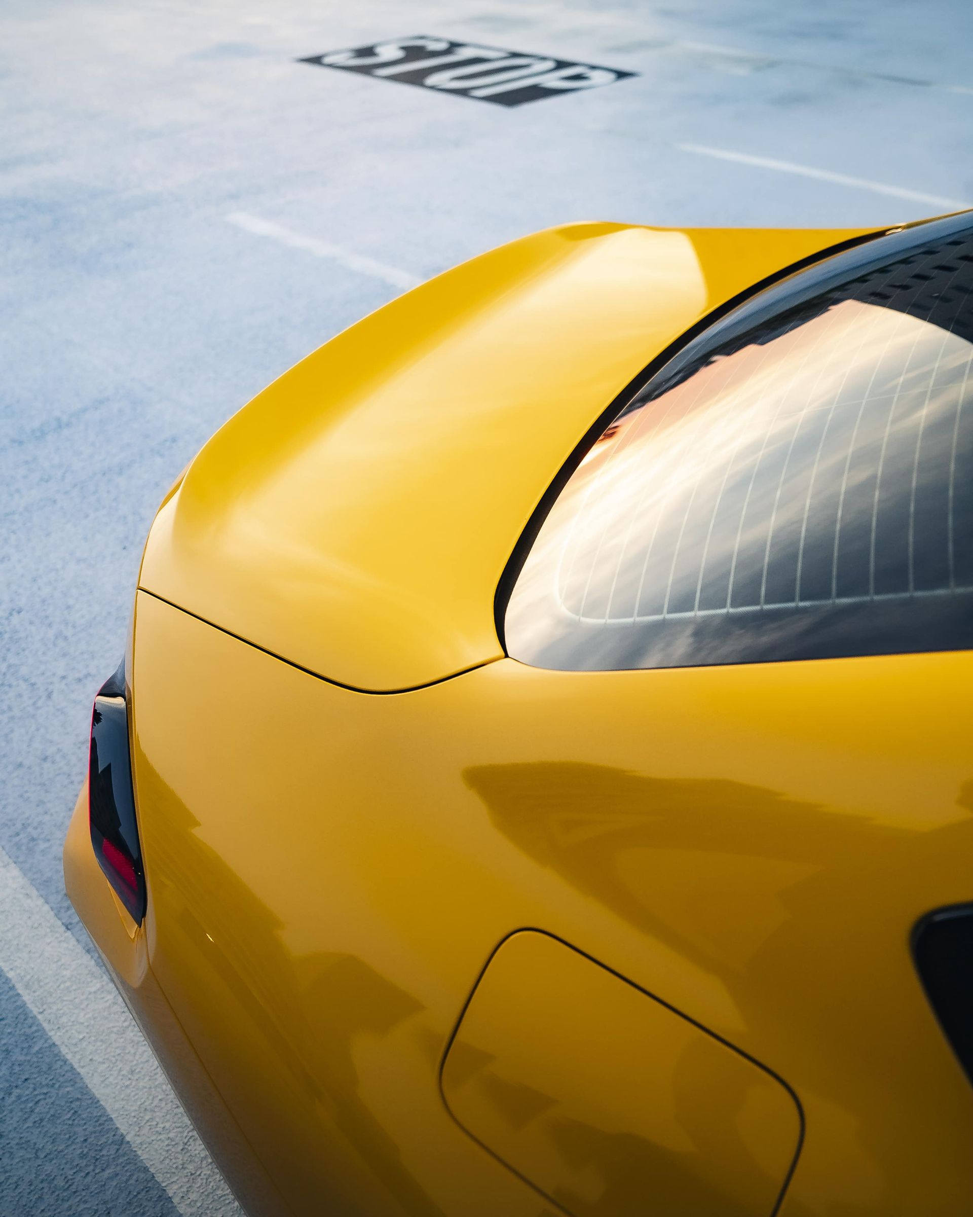 Yellow sports car parked in a parking space.