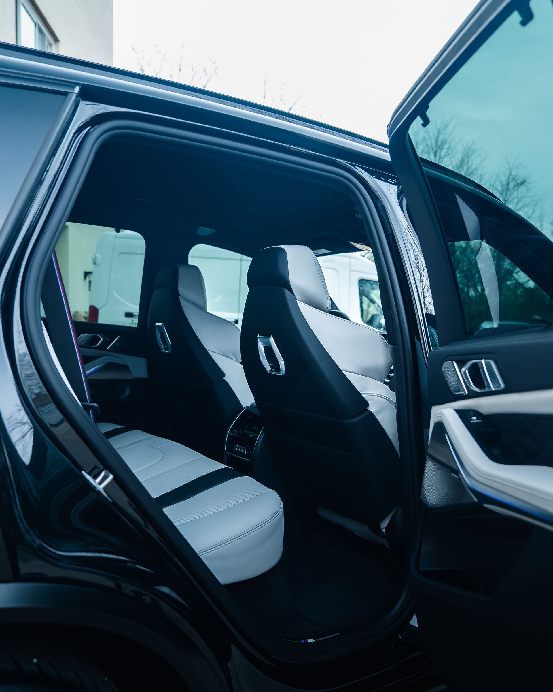 Black Nissan Z sports car with honeycomb design on its roof, in a shop.