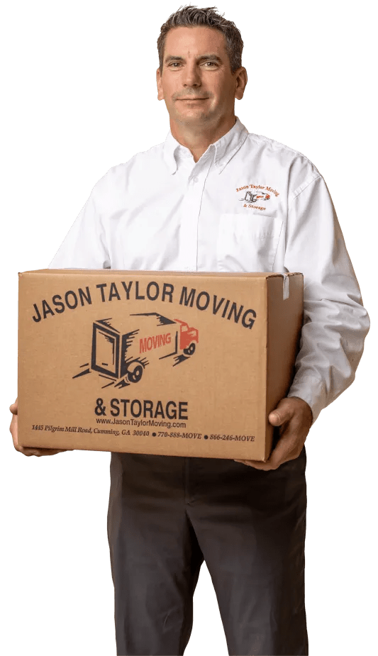 Man in white shirt holds a moving box for Jason Taylor Moving & Storage.