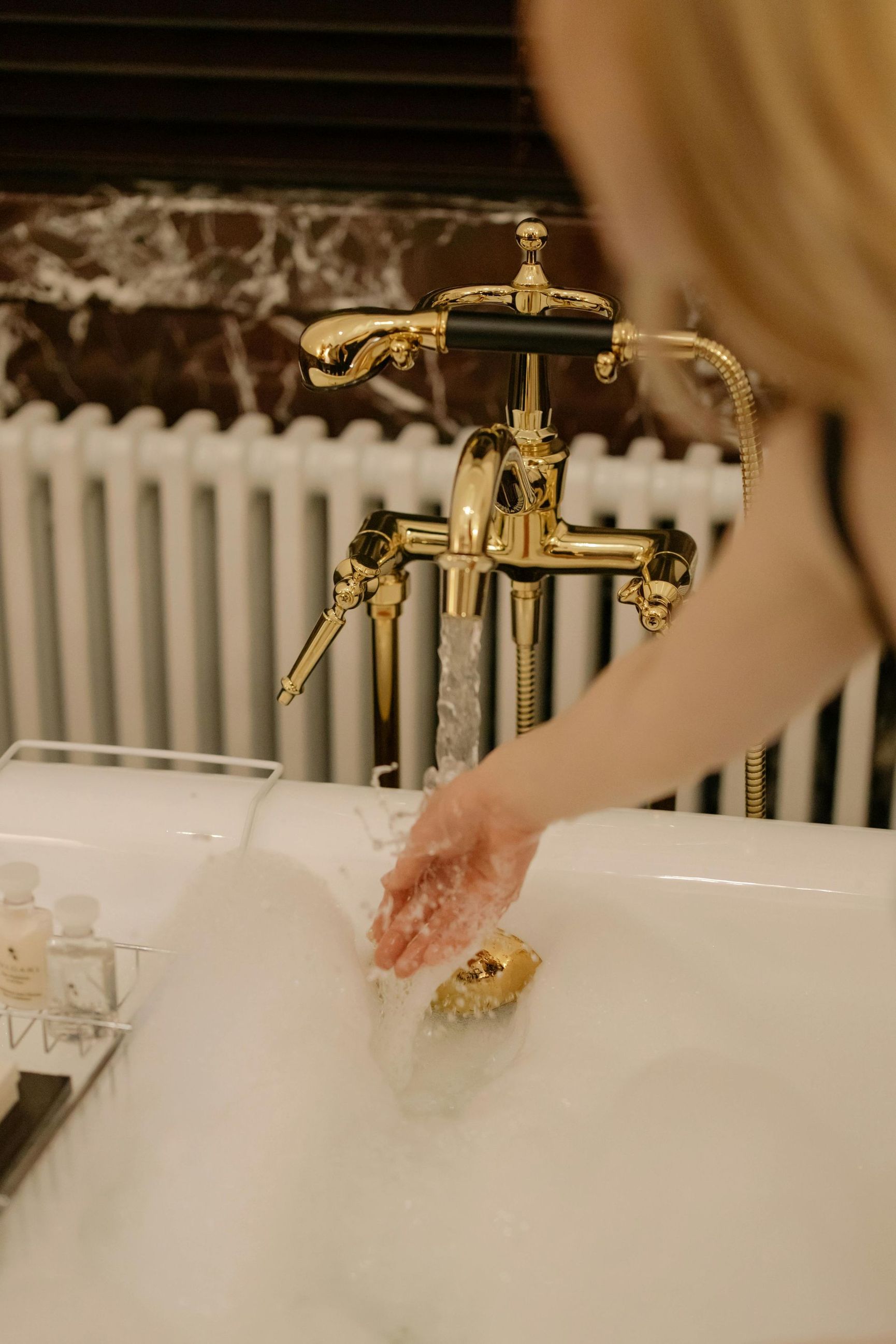 A woman is taking a bath in a bathtub filled with foam.