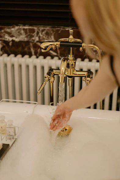 A woman is taking a bath in a bathtub filled with foam.