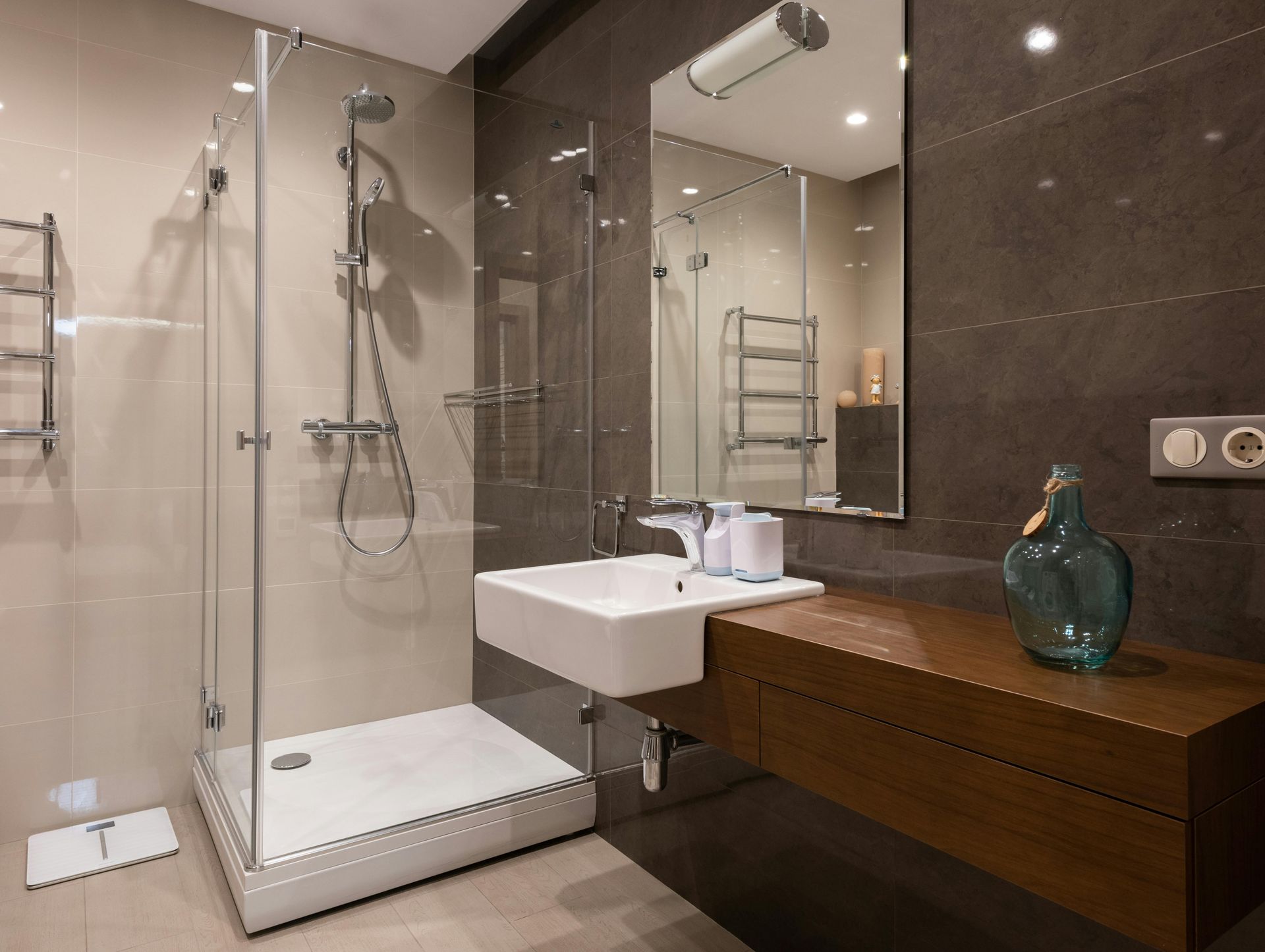 A bathroom with a sink and a walk in shower
